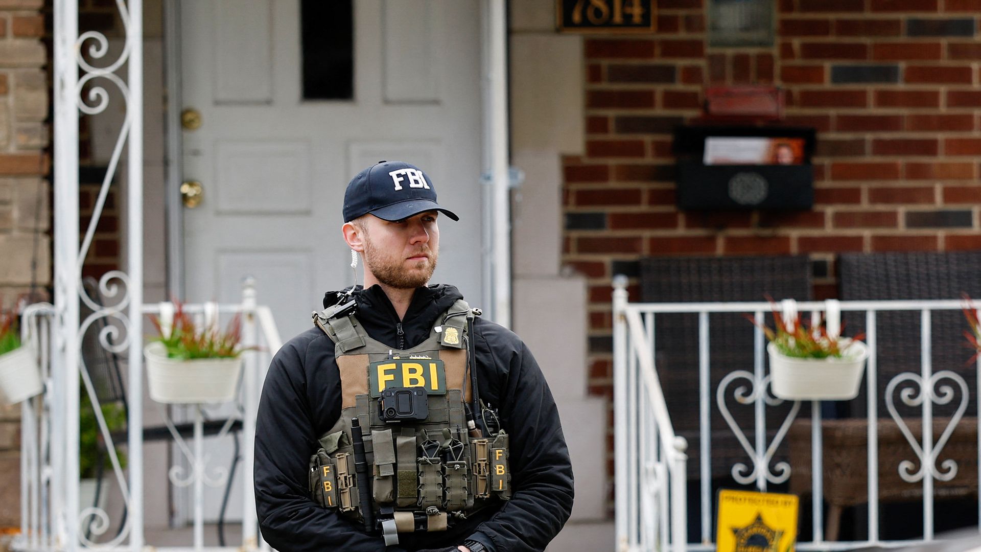 FBI agent wearing a black shirt, "FBI" vest and "FBI" hat