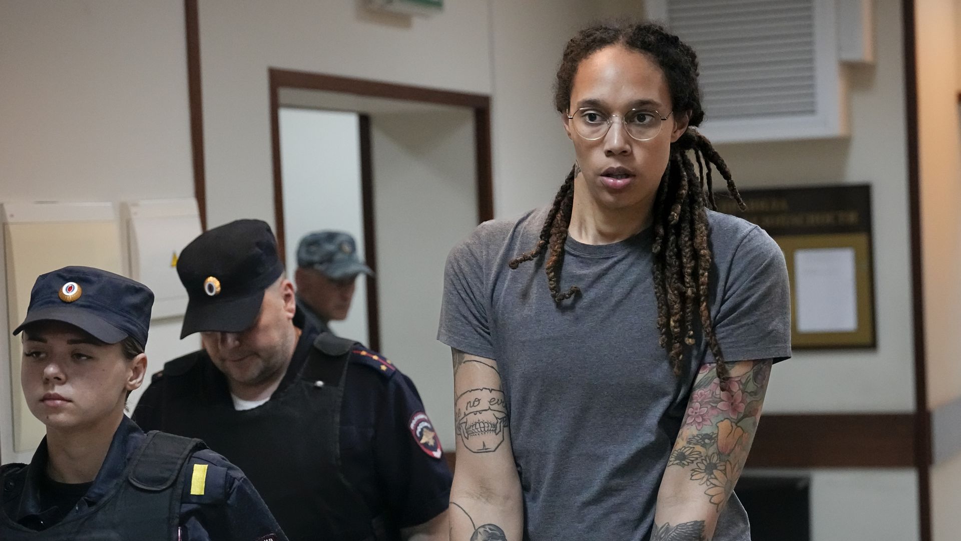 Guards escort Brittney Griner from a Russian courtroom