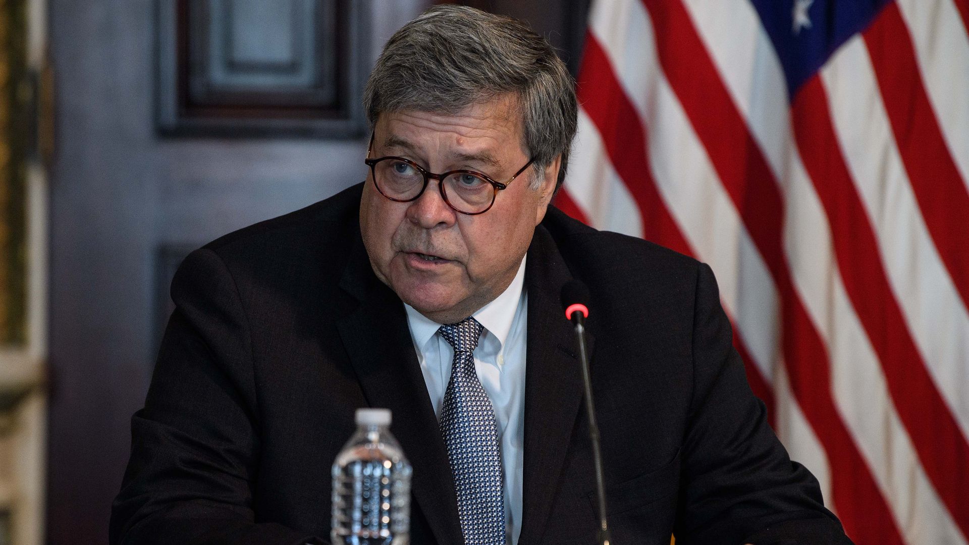 Attorney General Bill Barr speaks into a microphone at a roundtable