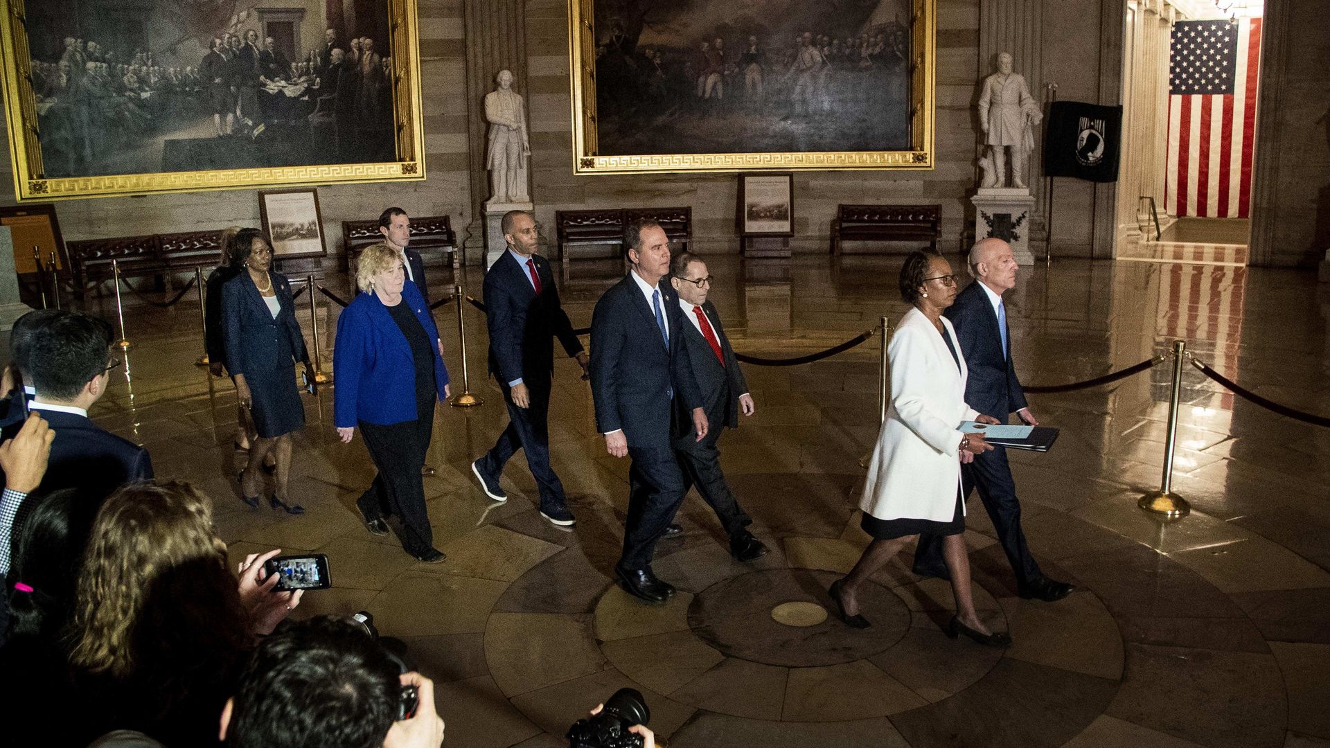 House managers walk through the Capitol Rotunda