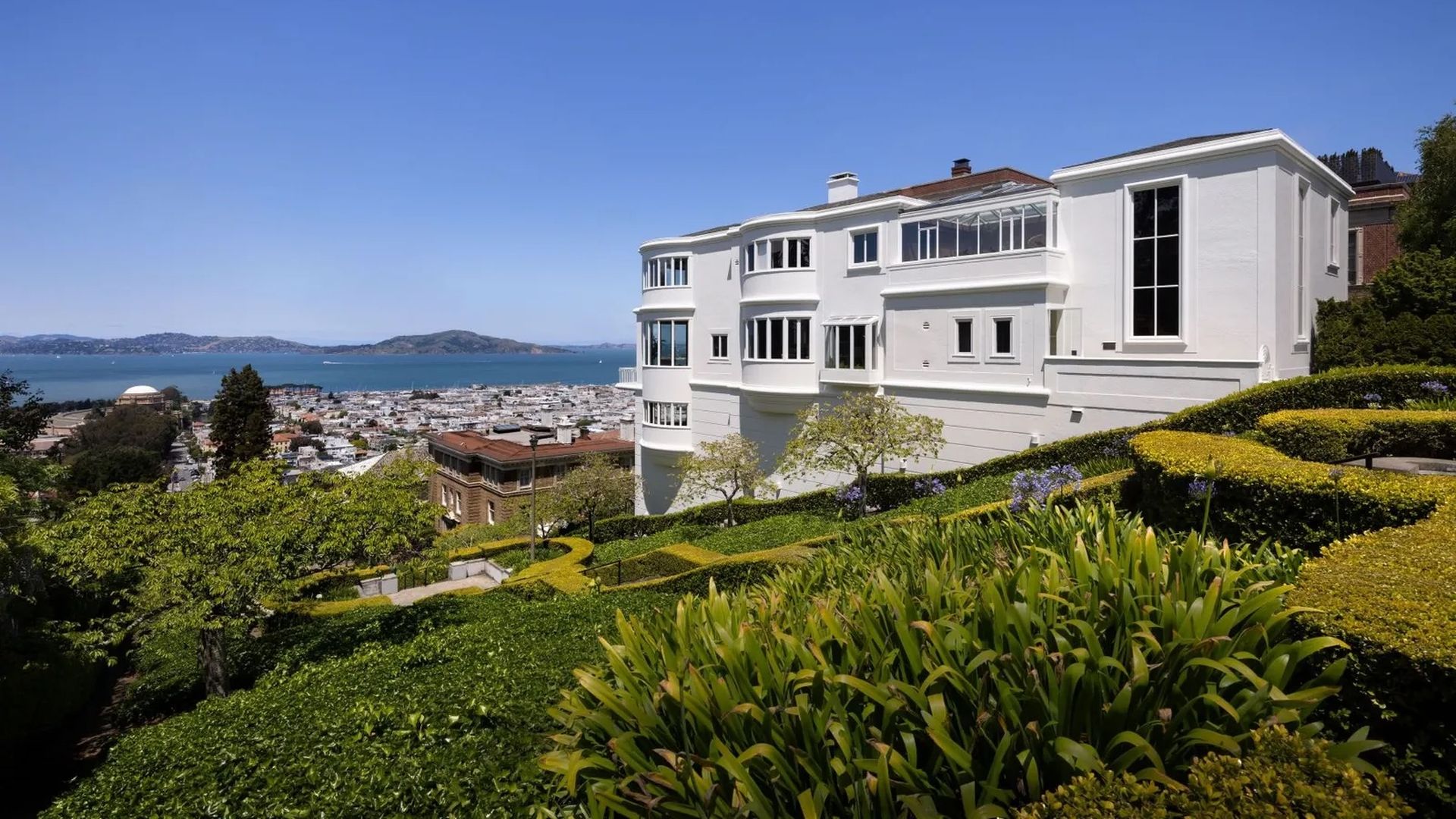 giant white house with the bay in the background