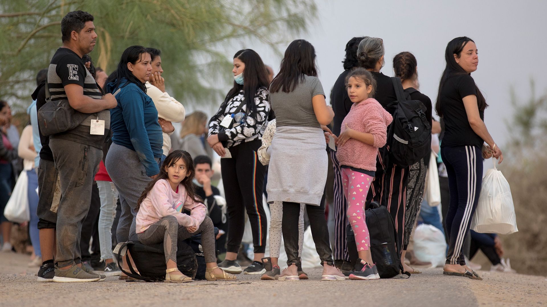 Migrants seeking asylum wait to board a bus at a checkpoint in Eagle Pass, Texas.