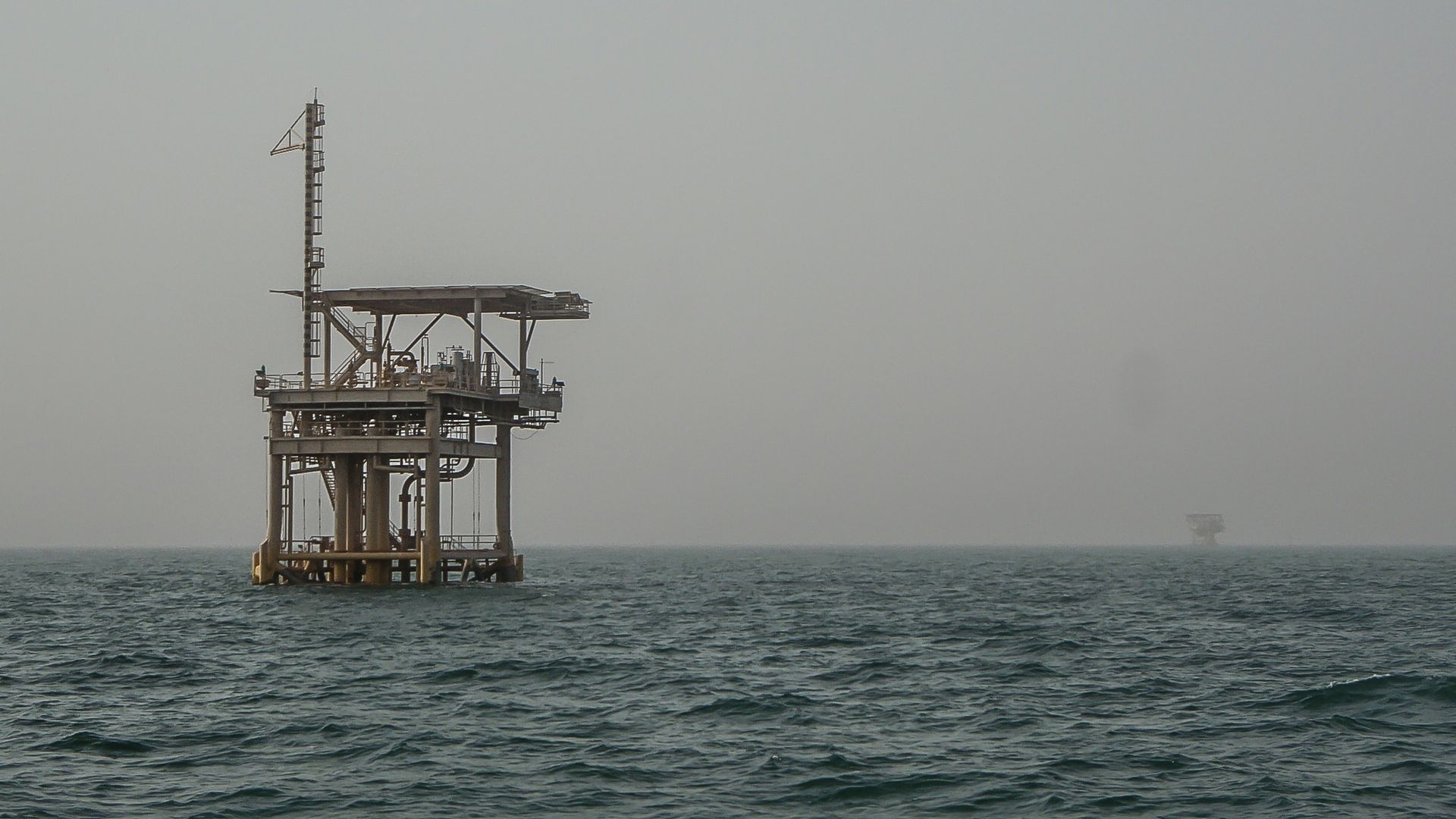 In this image, an oil rig sits in the ocean off the coast of Saudi Arabia.