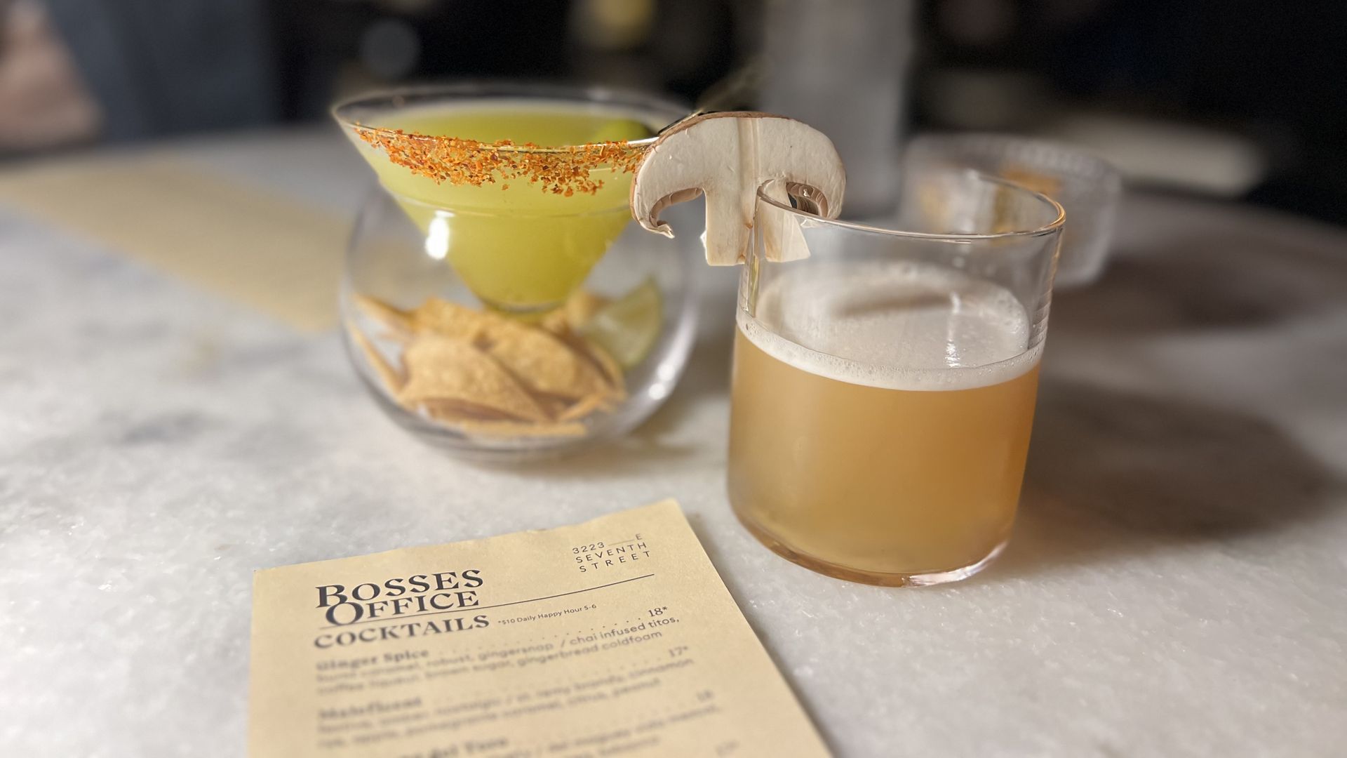 Two drinks with a menu in the foreground.