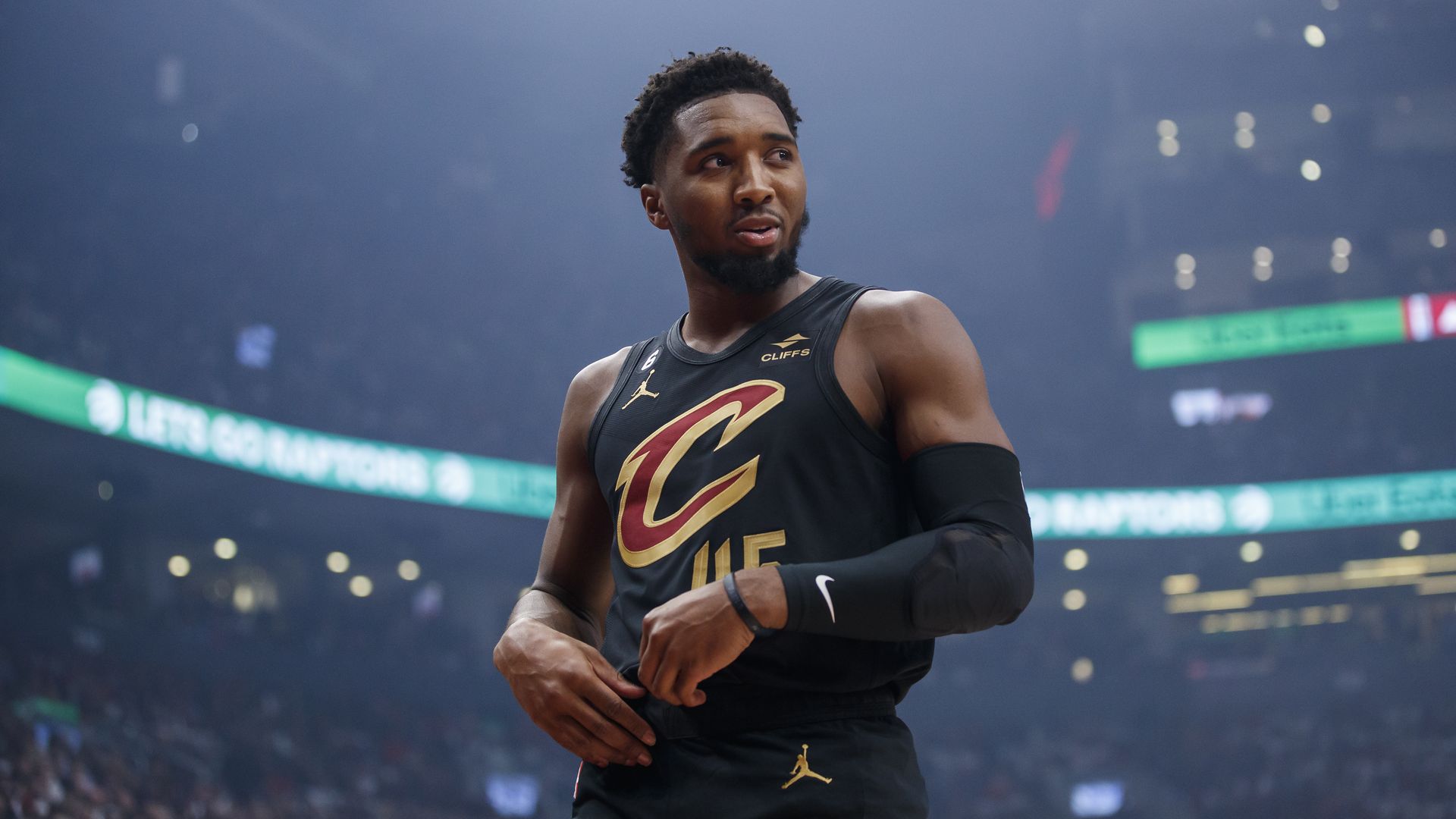 Donovan Mitchell in a black Cleveland Cavaliers uniform on the court before a game