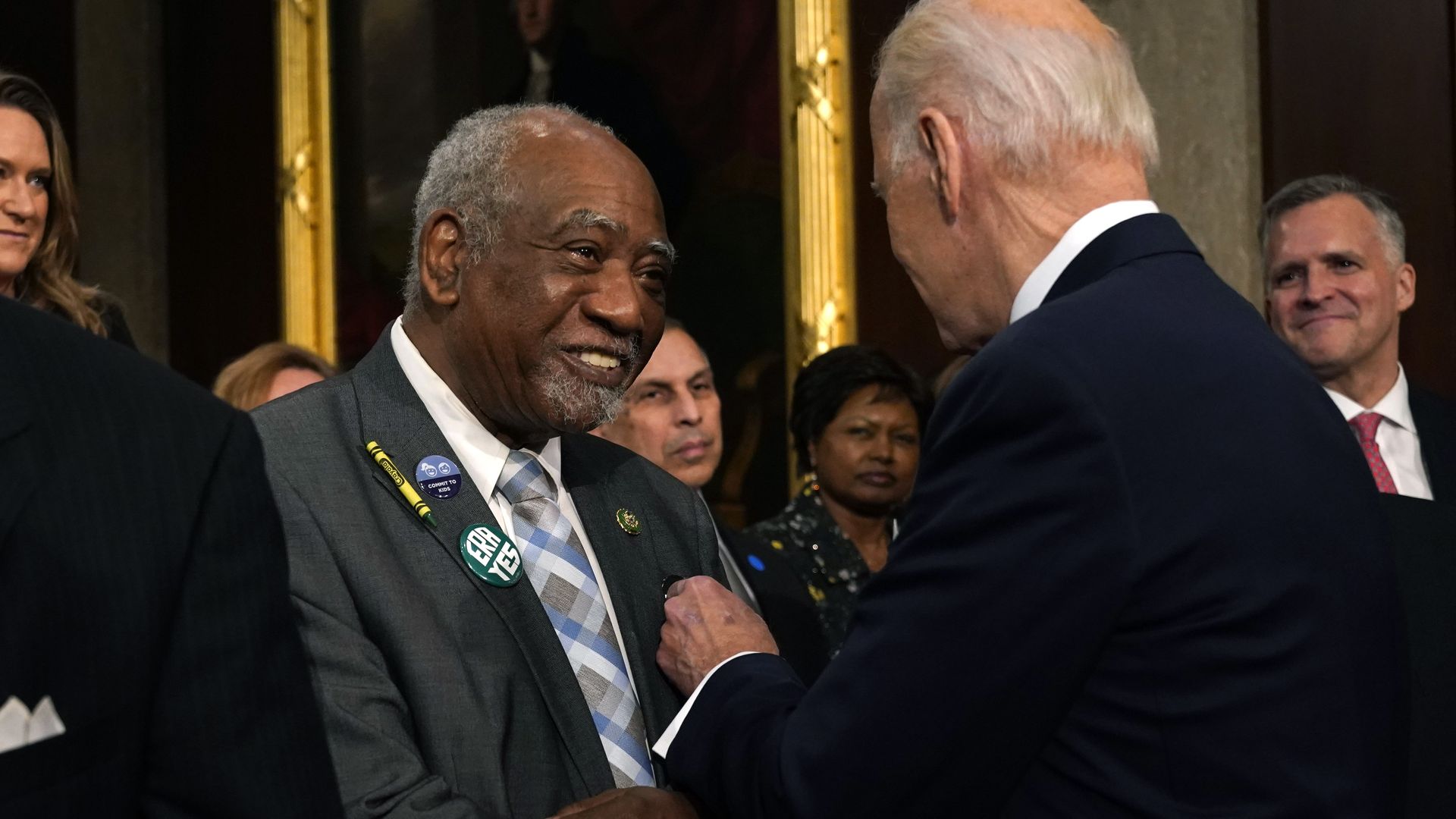 Photo of two men embracing at a gathering