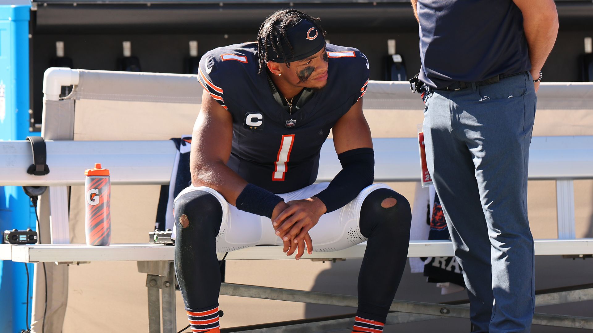 Photo of a football player on a bench. 