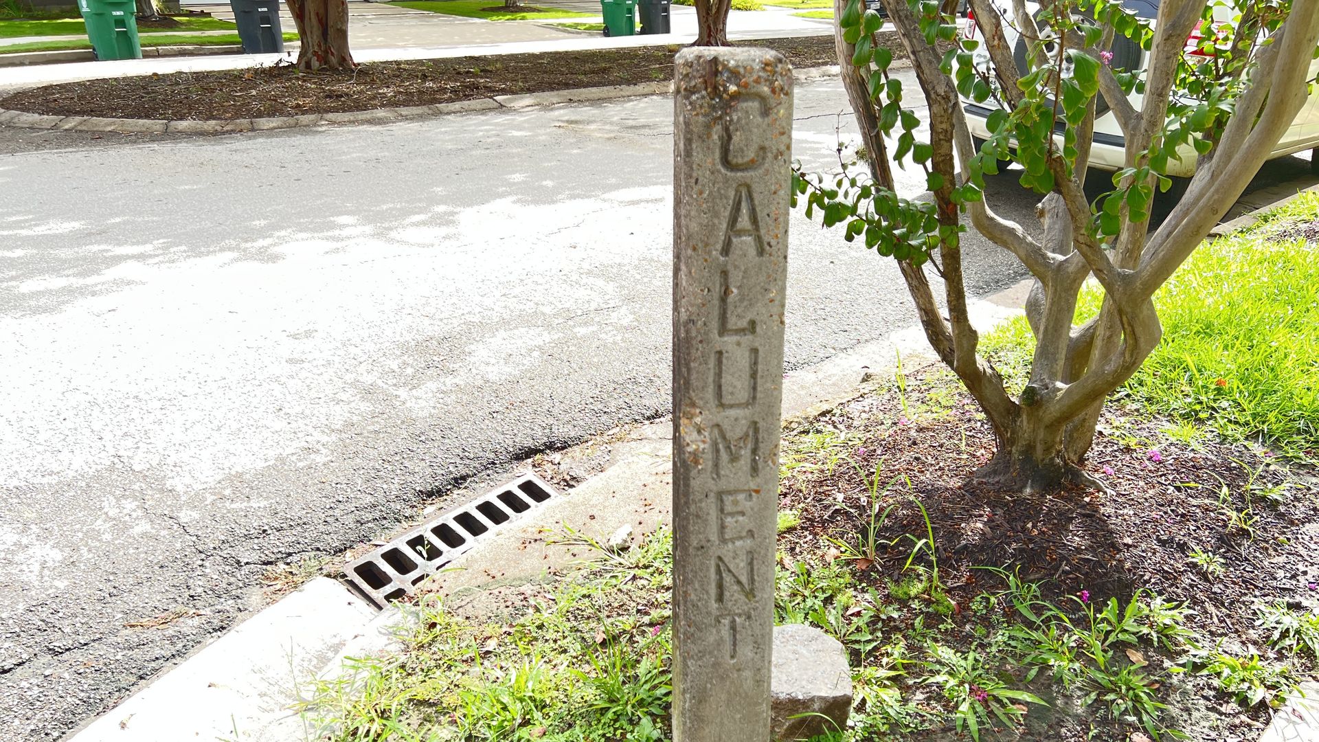 Photo of a four-foot-tall concrete pillar inscribed with with "Calument"