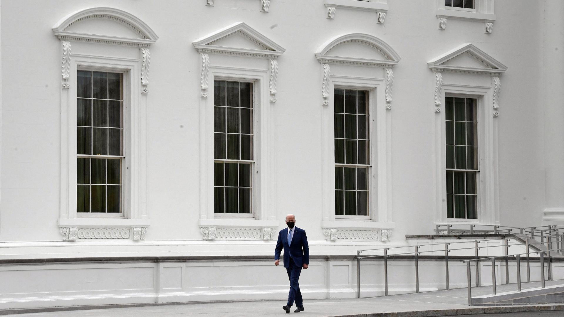 President Biden is seen walking against the backdrop of the White House last Friday.