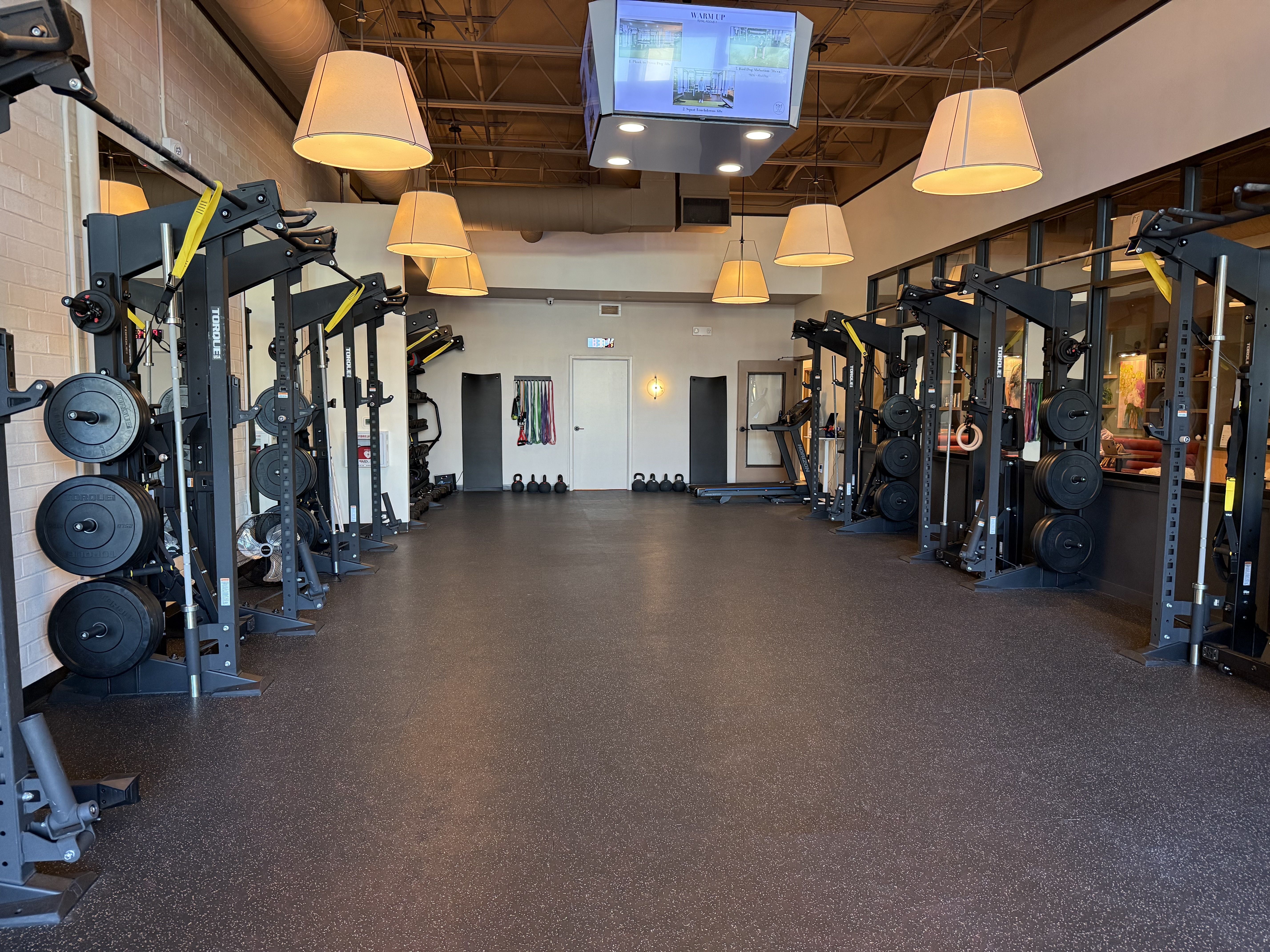 The strength training room is line wall to wall with squat racks. Your first class is free.