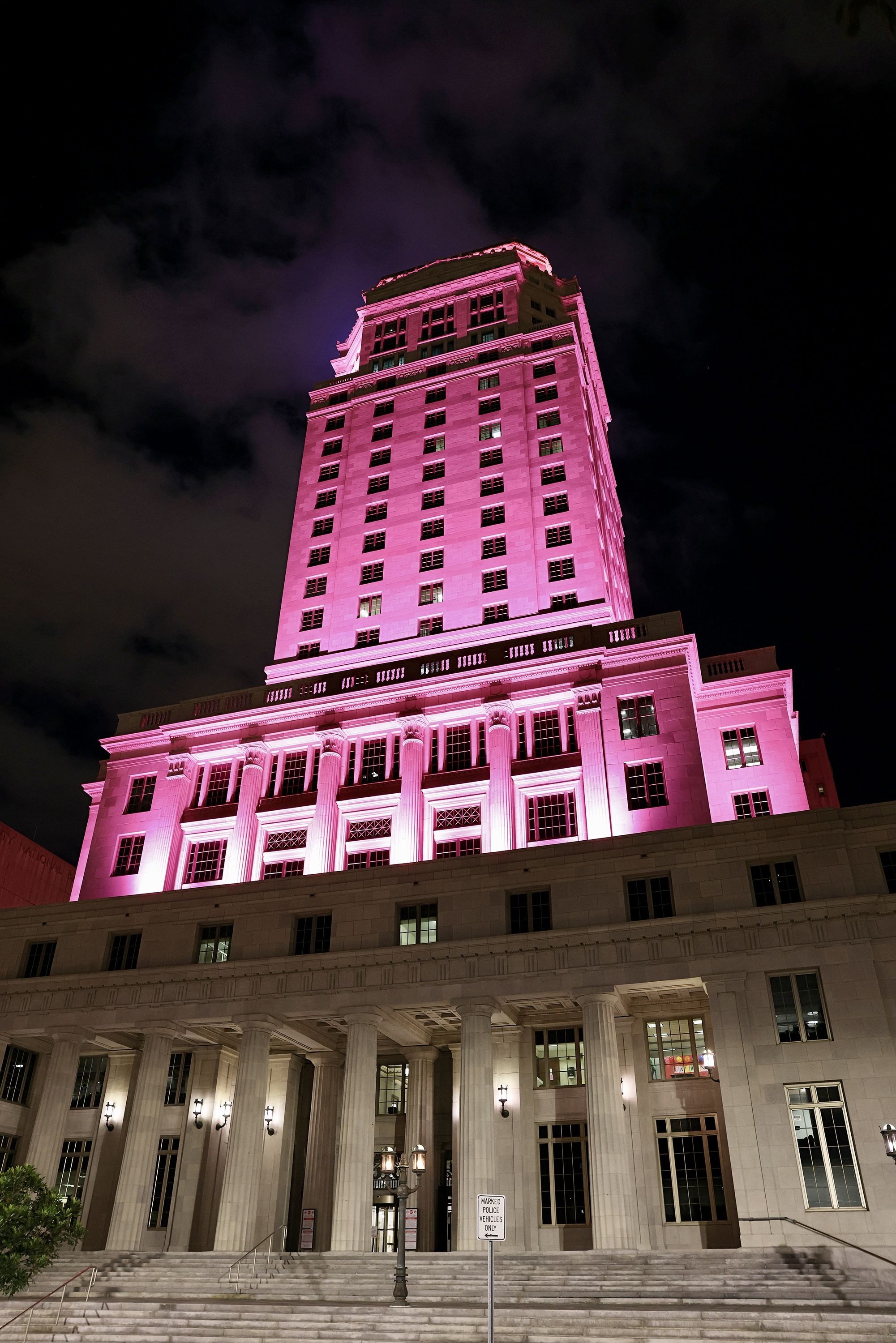 The Miami-Dade County Courthouse illuminates a colored light in honor of COVID-19 victims