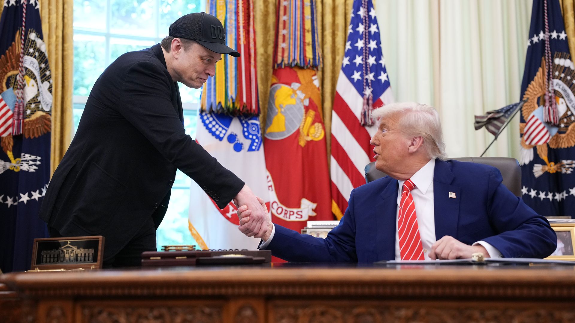 Tesla CEO Elon Musk shakes hands with U.S. President Donald Trump as they speak to reporters in the Oval Office of the White House on May 30, 2025 in Washington, DC. 