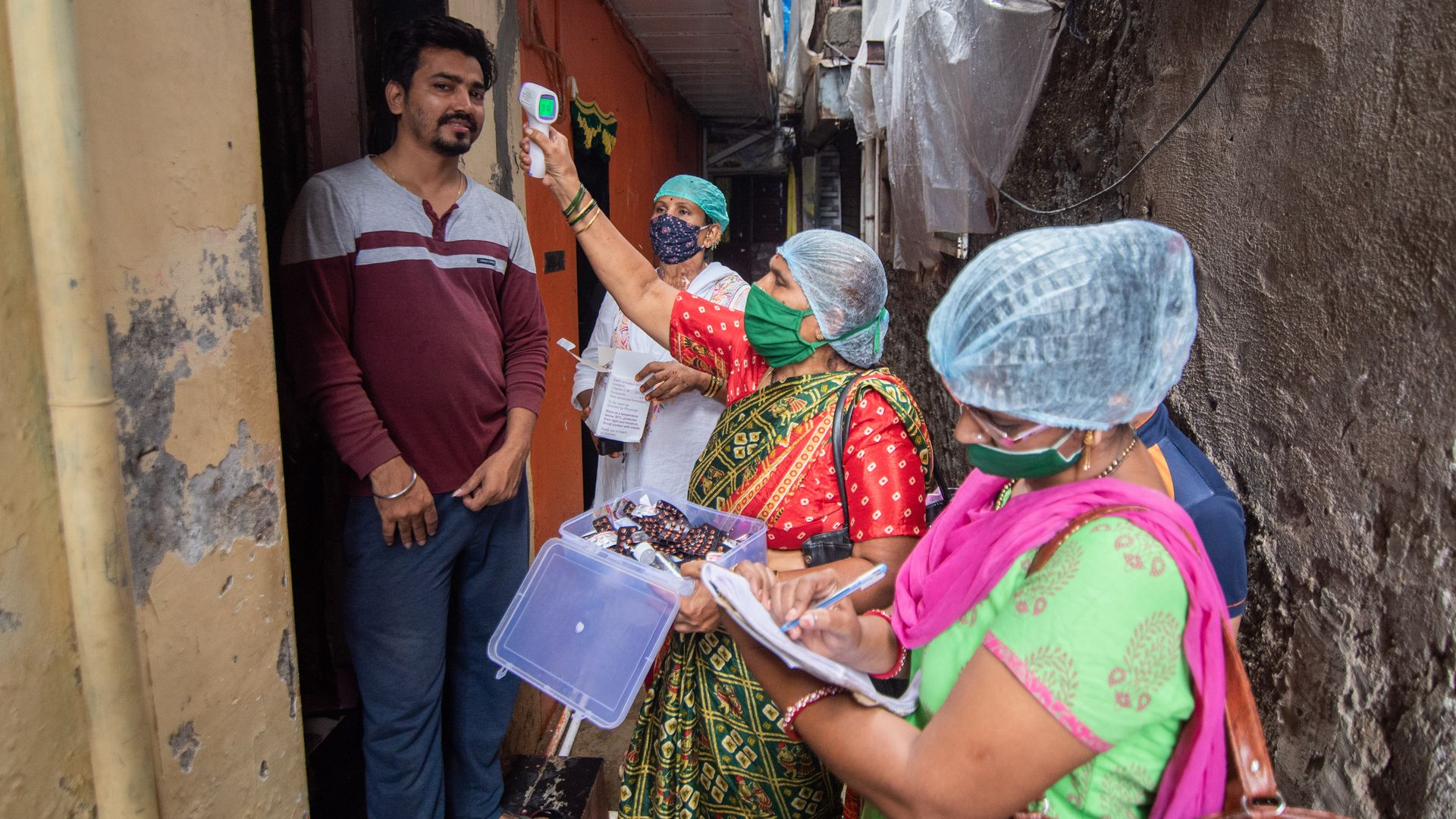  Health care workers during door to door screening of Temperature and Oxygen level test at Saki naka during Covid-19 pandemic, on August 30, 2020 in Mumbai, India. 