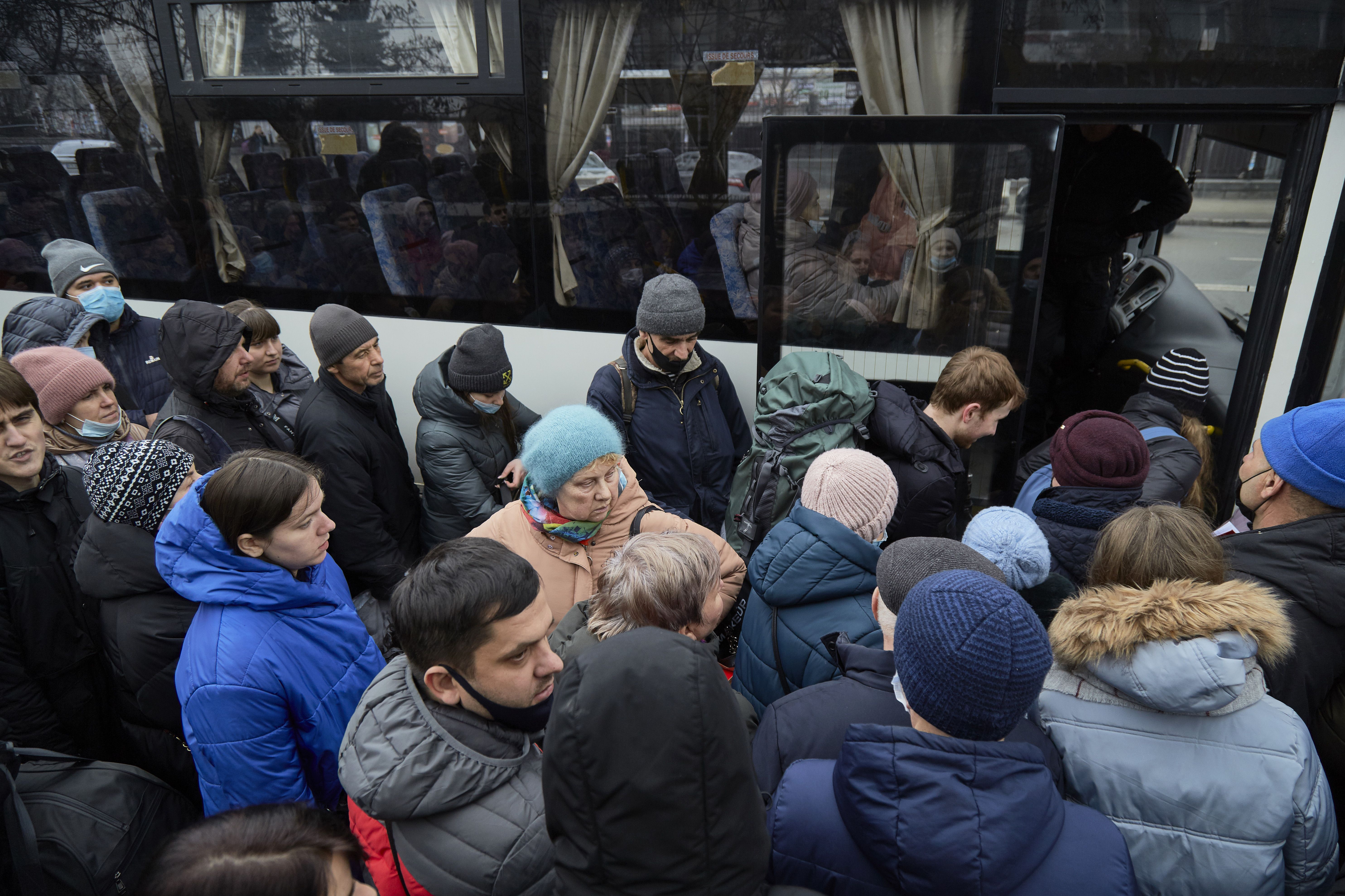 Photo of people crowding at the entrance of a bus