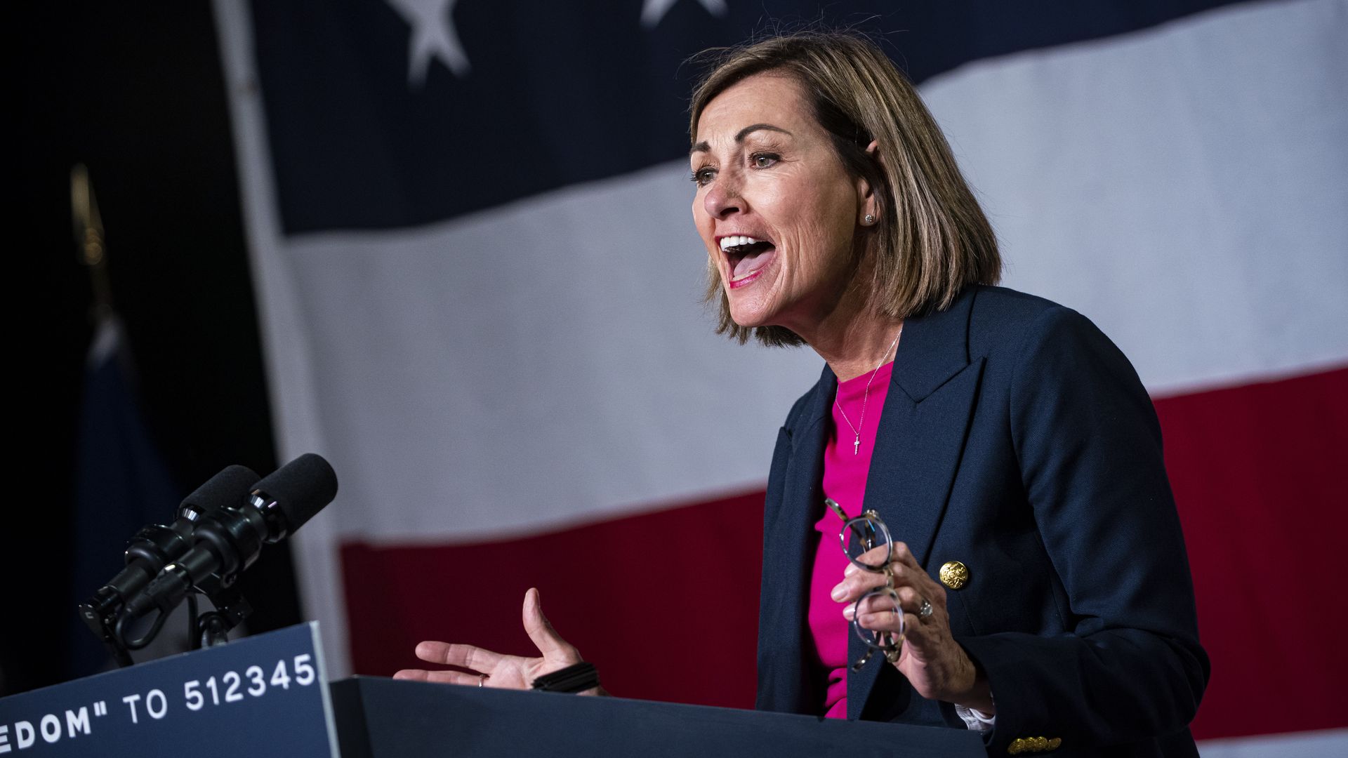 Kim Reynolds at podium for Ron DeSantis event