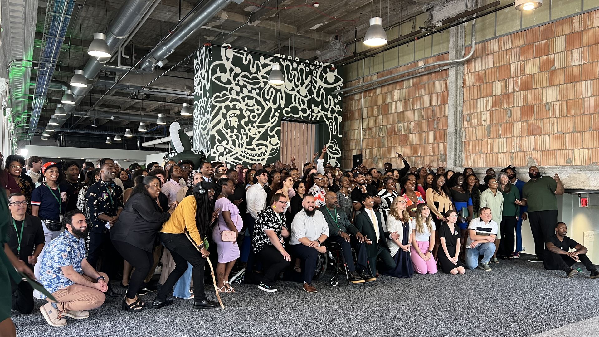 Apple Developer Academy's 2023 graduating class inside the First National Bank building downtown.