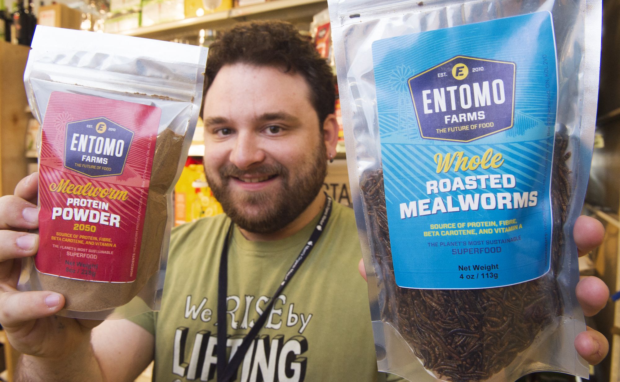 A man holding edible insect products. Photo by Paul J. RICHARDS / AFP) (Photo by PAUL J. RICHARDS/AFP via Getty Images