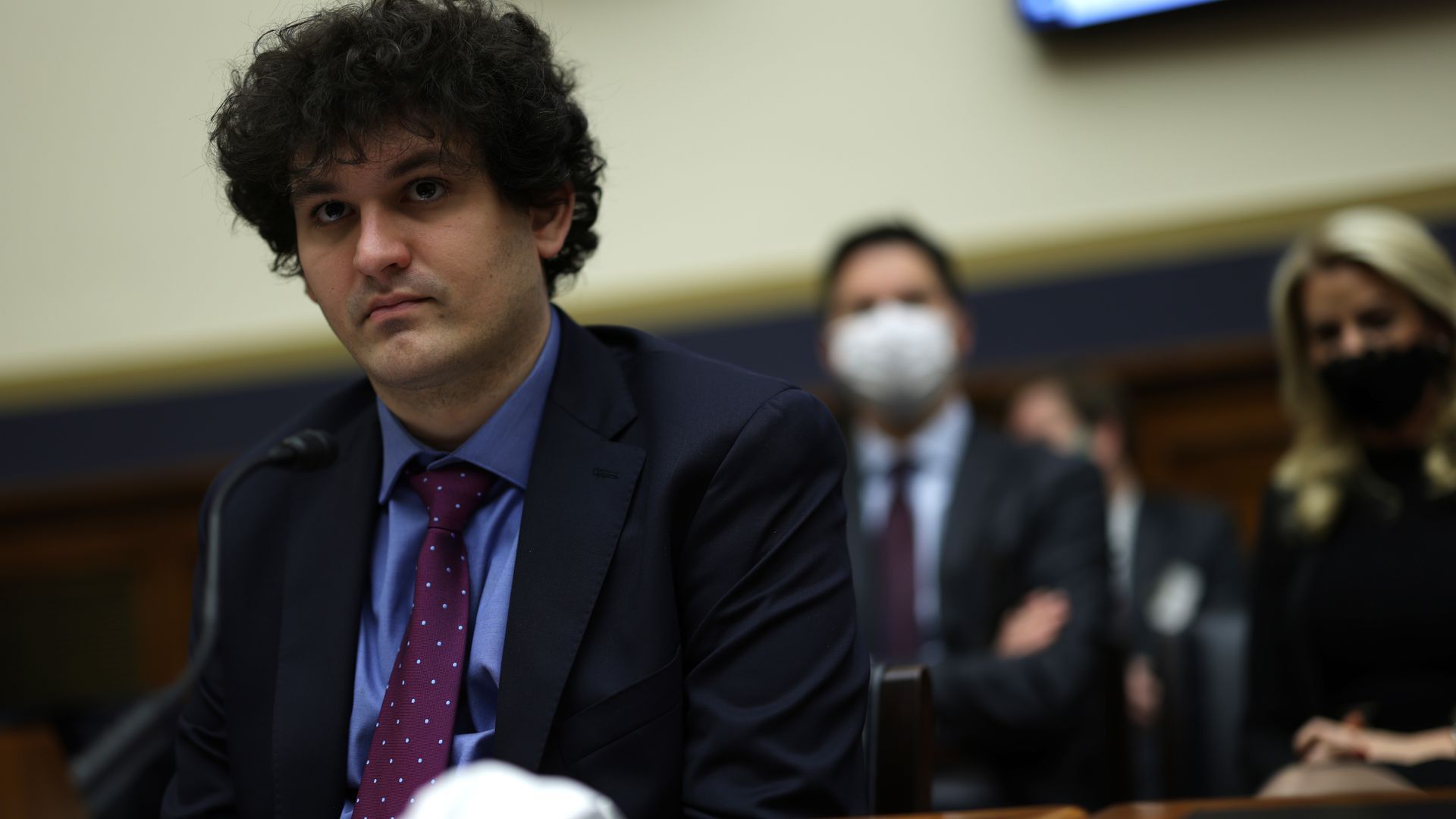 FTX CEO San Bankman-Fried sits at a table during a Congressional hearing.
