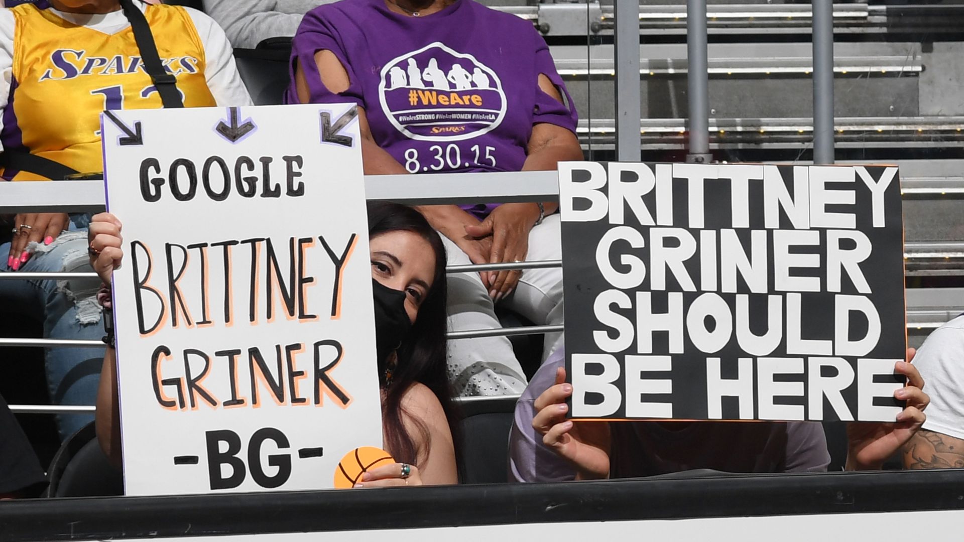Fans hold signs supporting Brittney Griner.