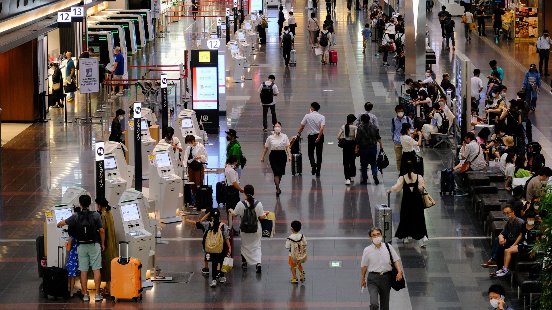 Masked travelers at the Tokyo International Airport