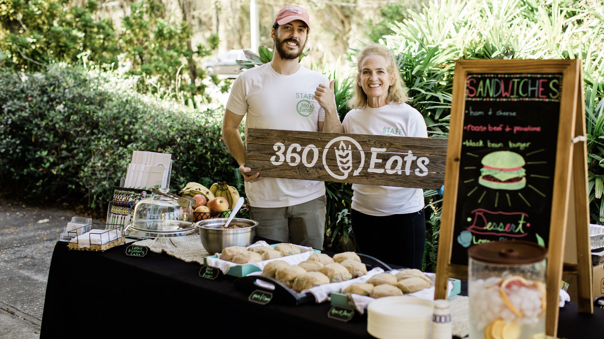 Cameron and Ellen Macleish holding a 360 Eats sign