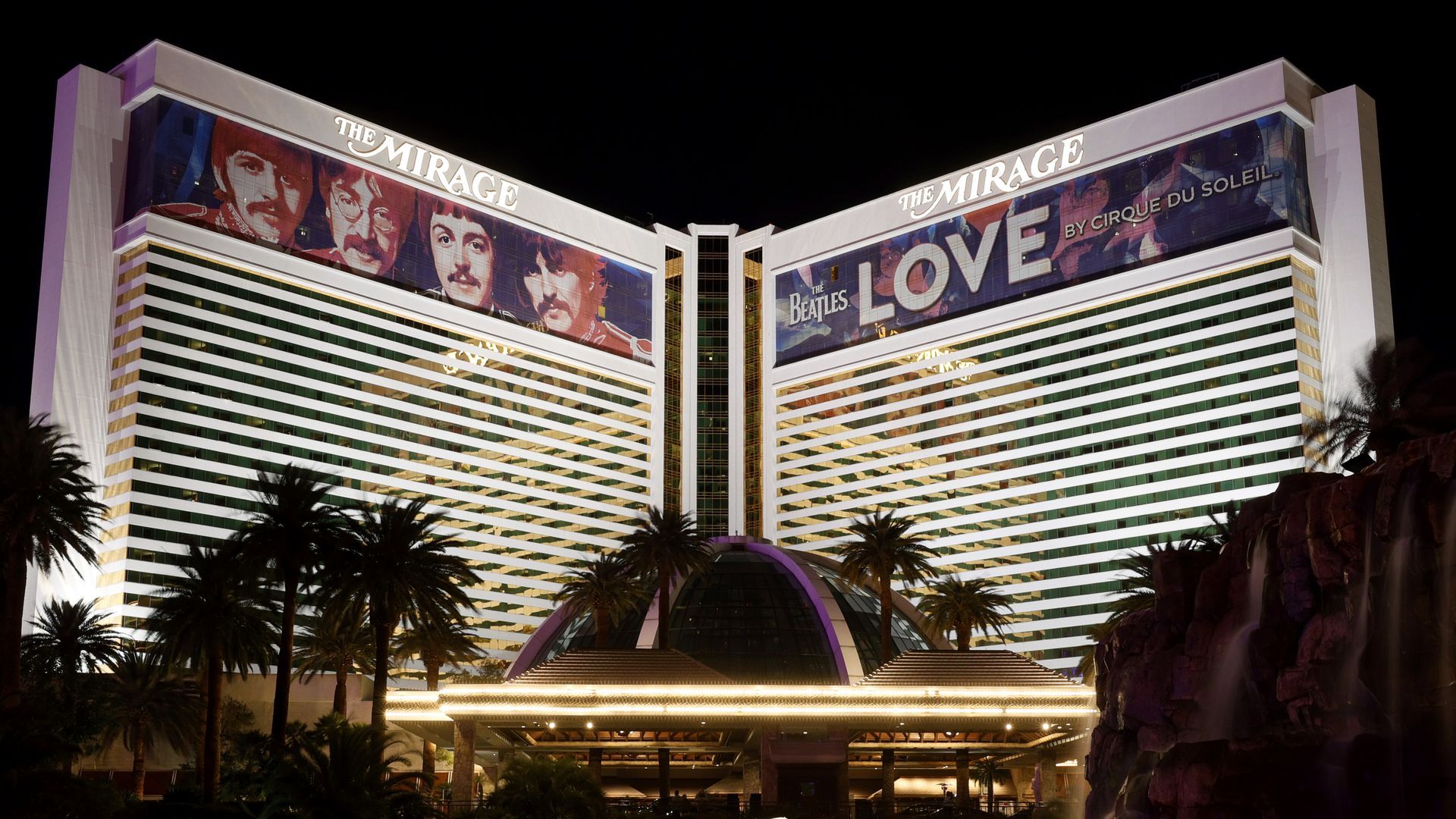 Picture of the Mirage casino with pictures of the Beatles at the top
