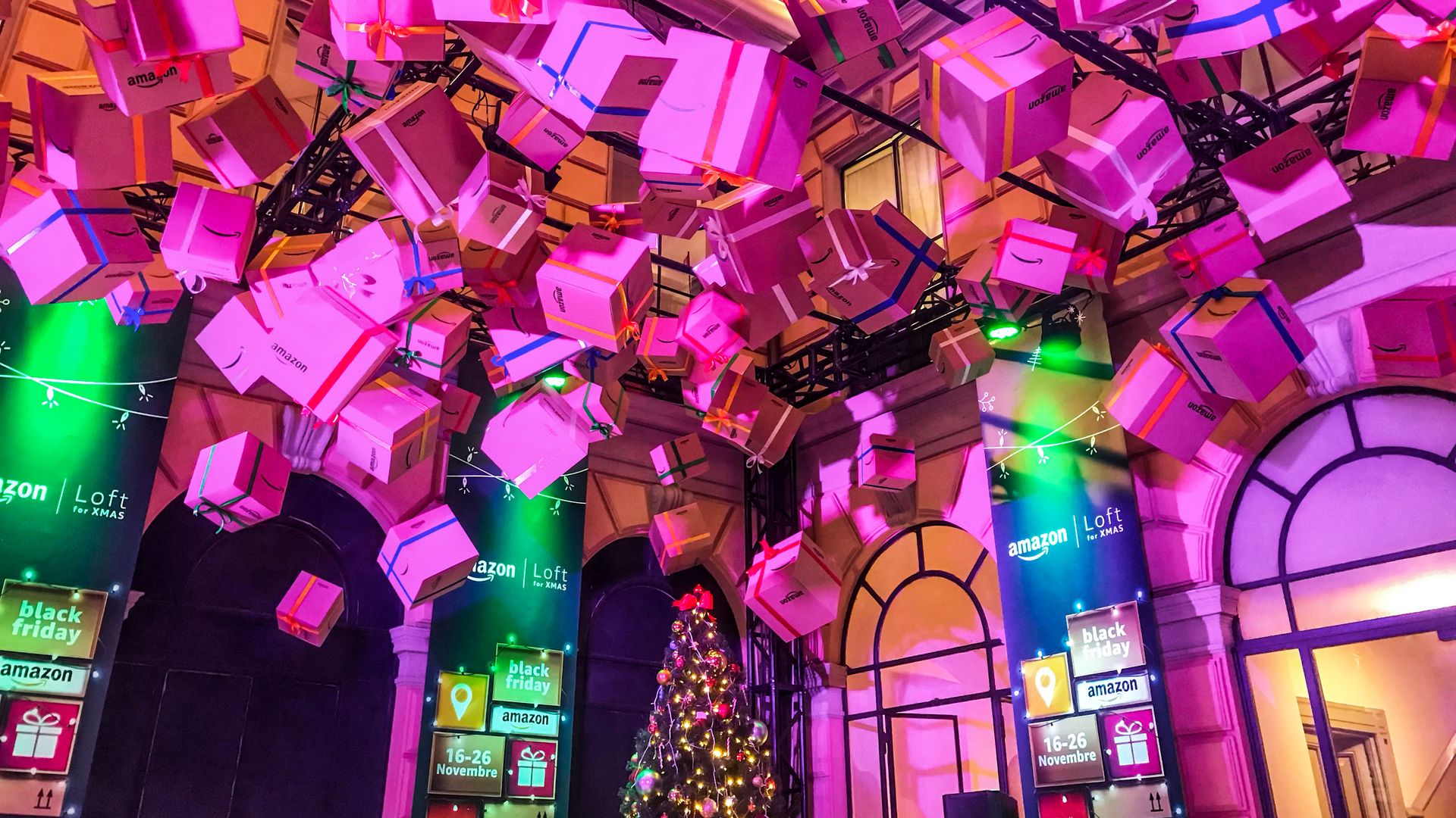 Pink presents hang over a Christmas tree