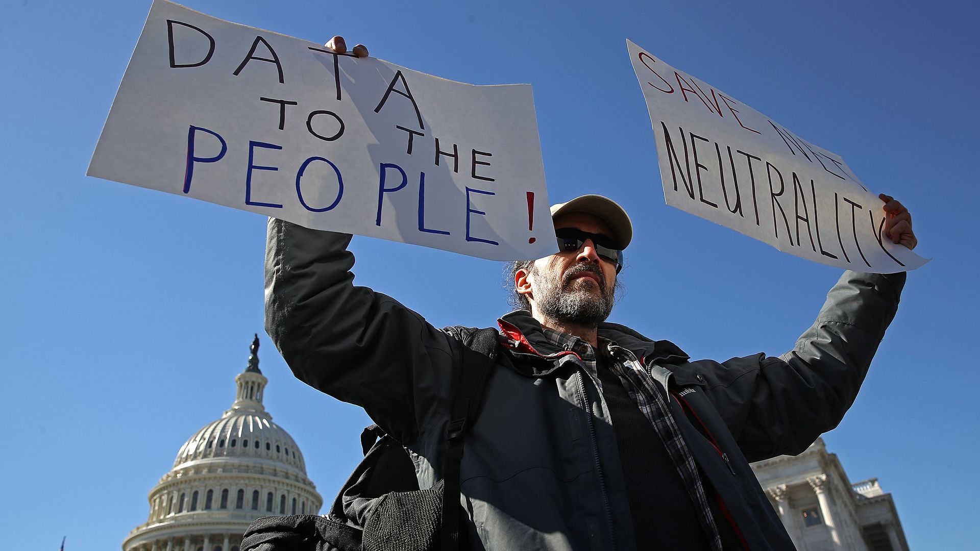 Protester with net neutrality signs