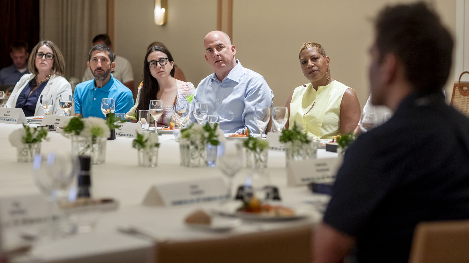 Jennifer Helm, Robert Rakowitz, Kerry Flynn, Chris Deri and Lisa Osborne Ross seated at a table with a white tablecloth and flowers