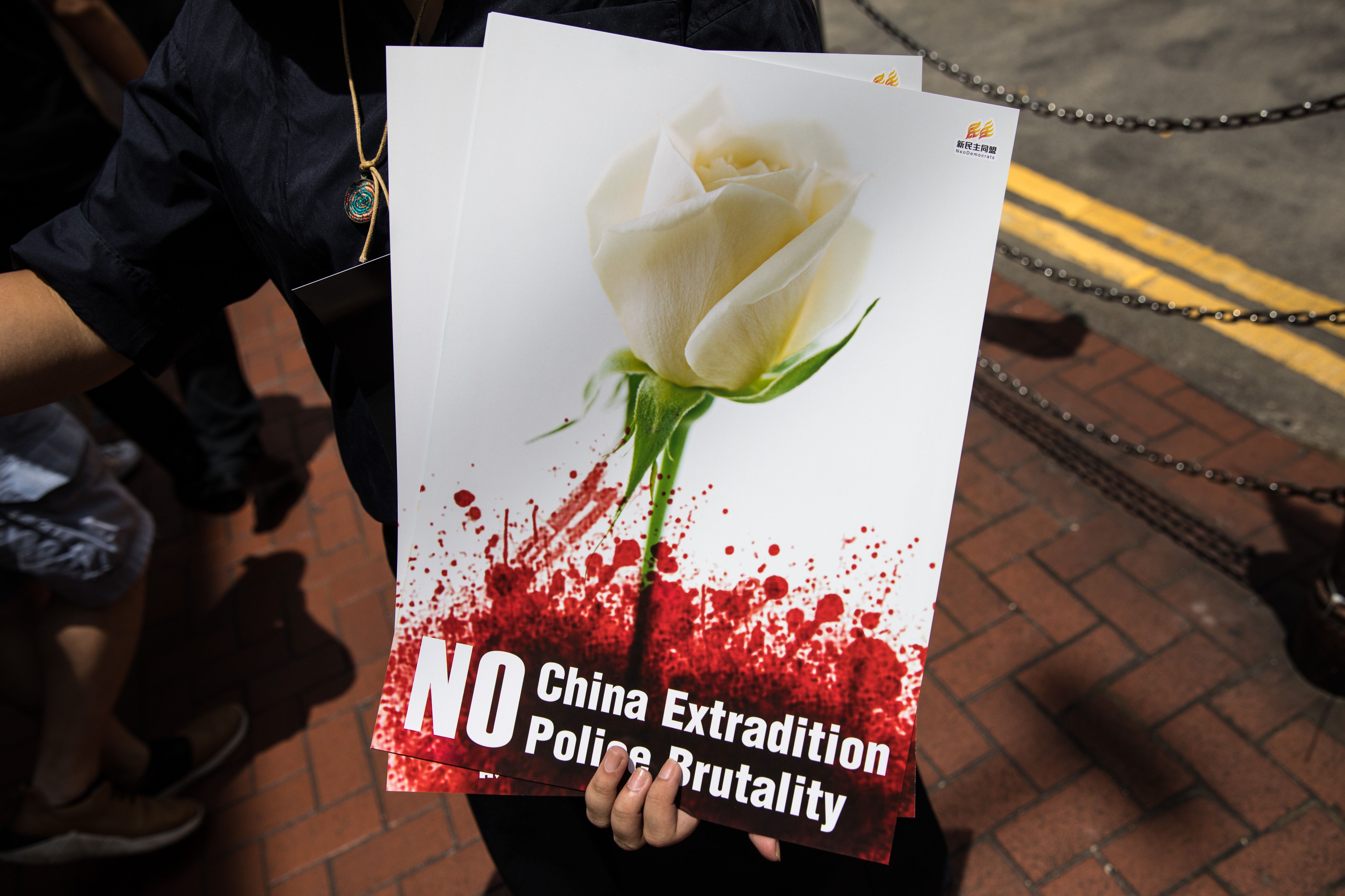 A protester hands out posters before a rally against a controversial extradition law proposal in Hong Kong on June 16, 2019.