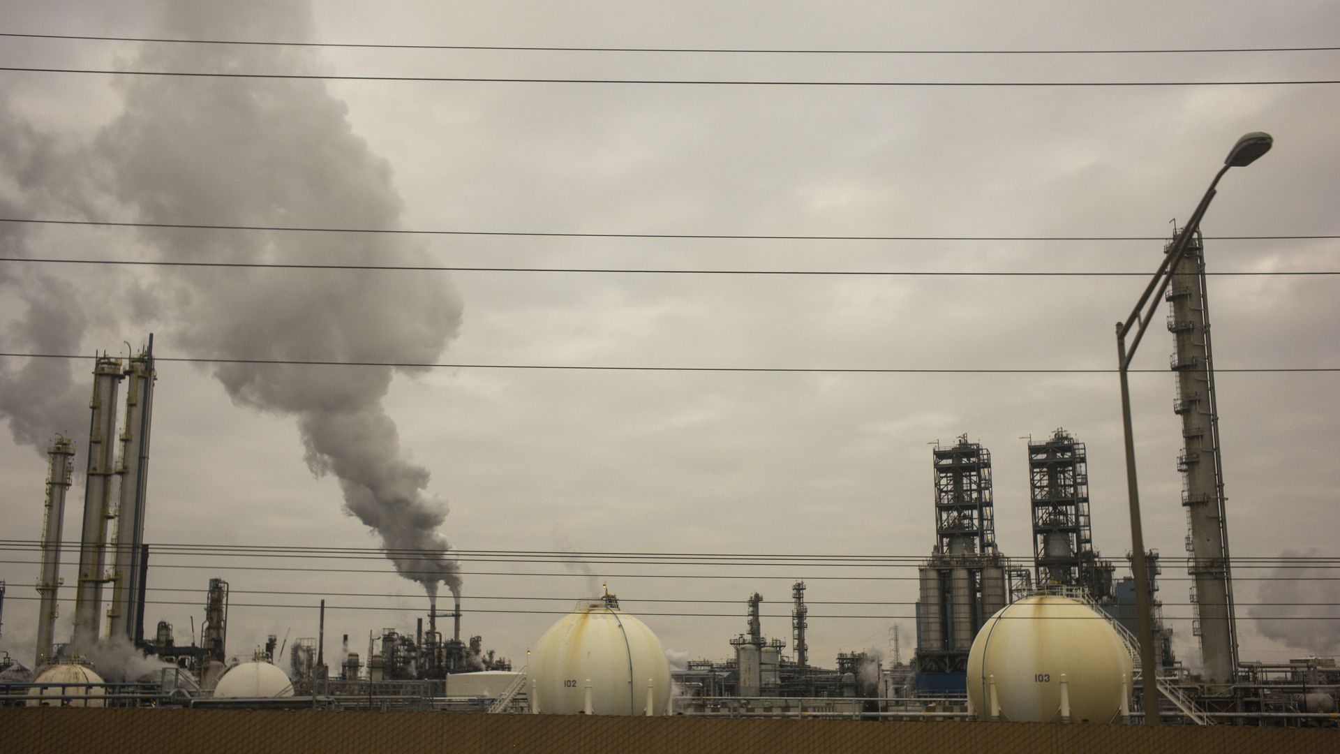 In this image, smoke pollution rises from a factory