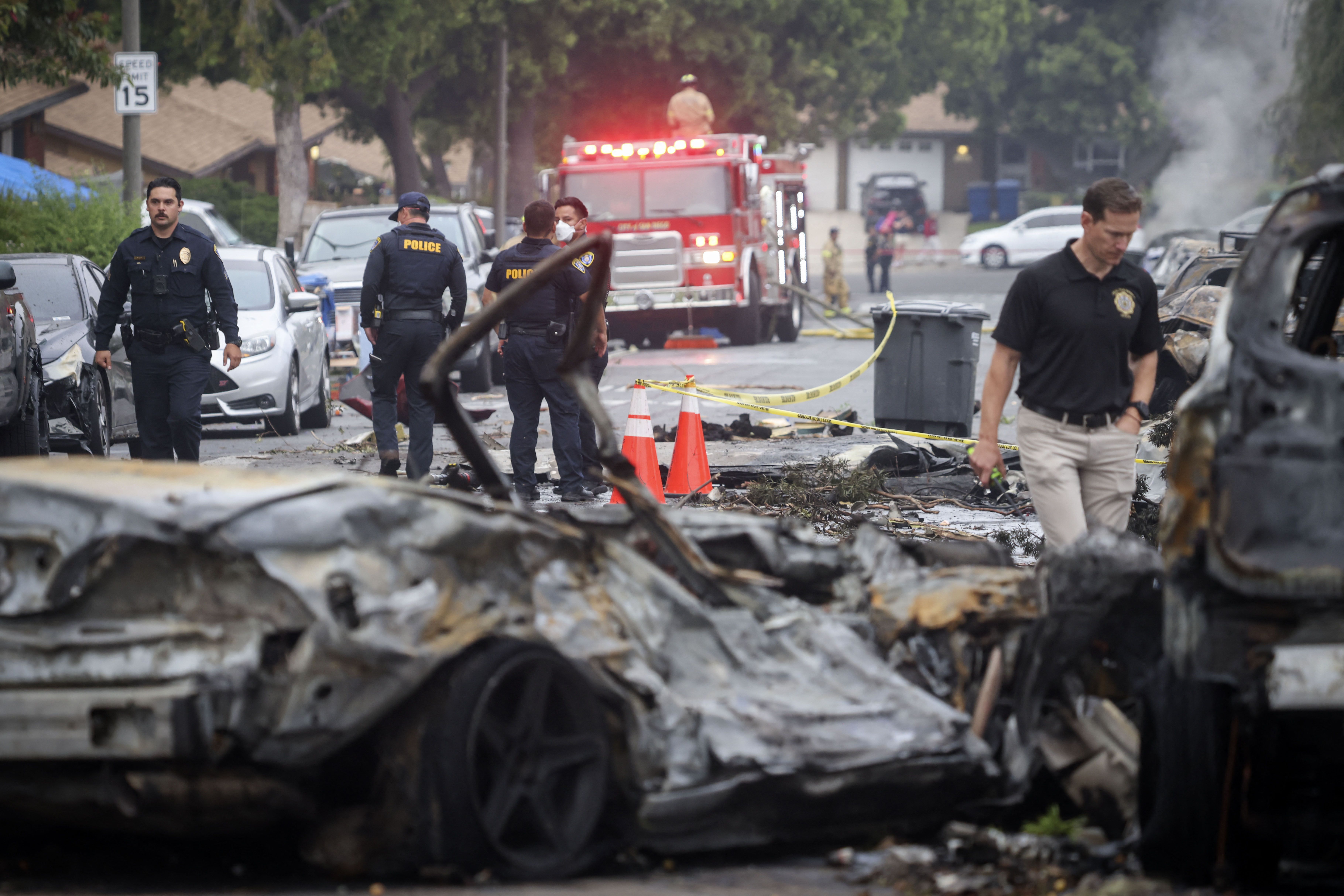  Investigators look through the site where a small plane crashed into San Diego, California, residential street on May 22, 2025. T
