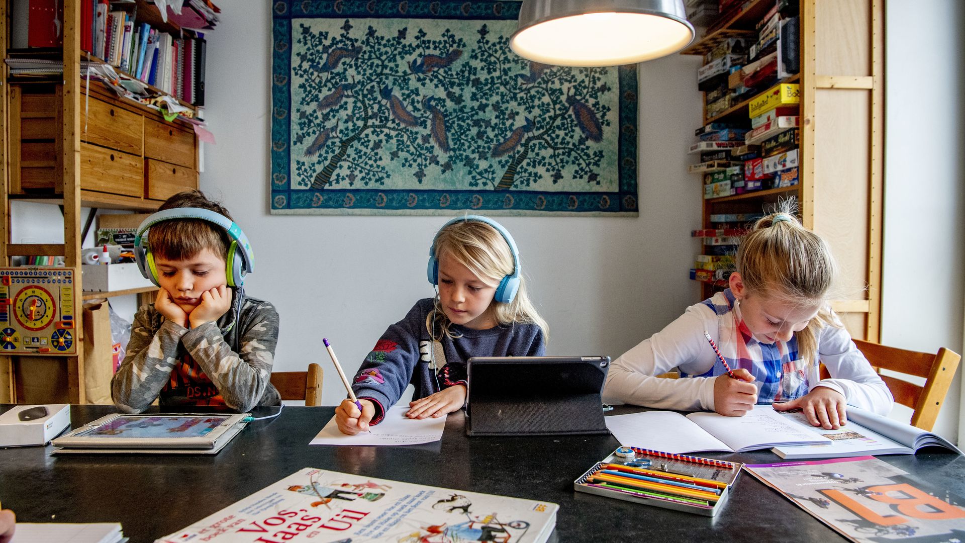 Three young students taking class on laptop computers