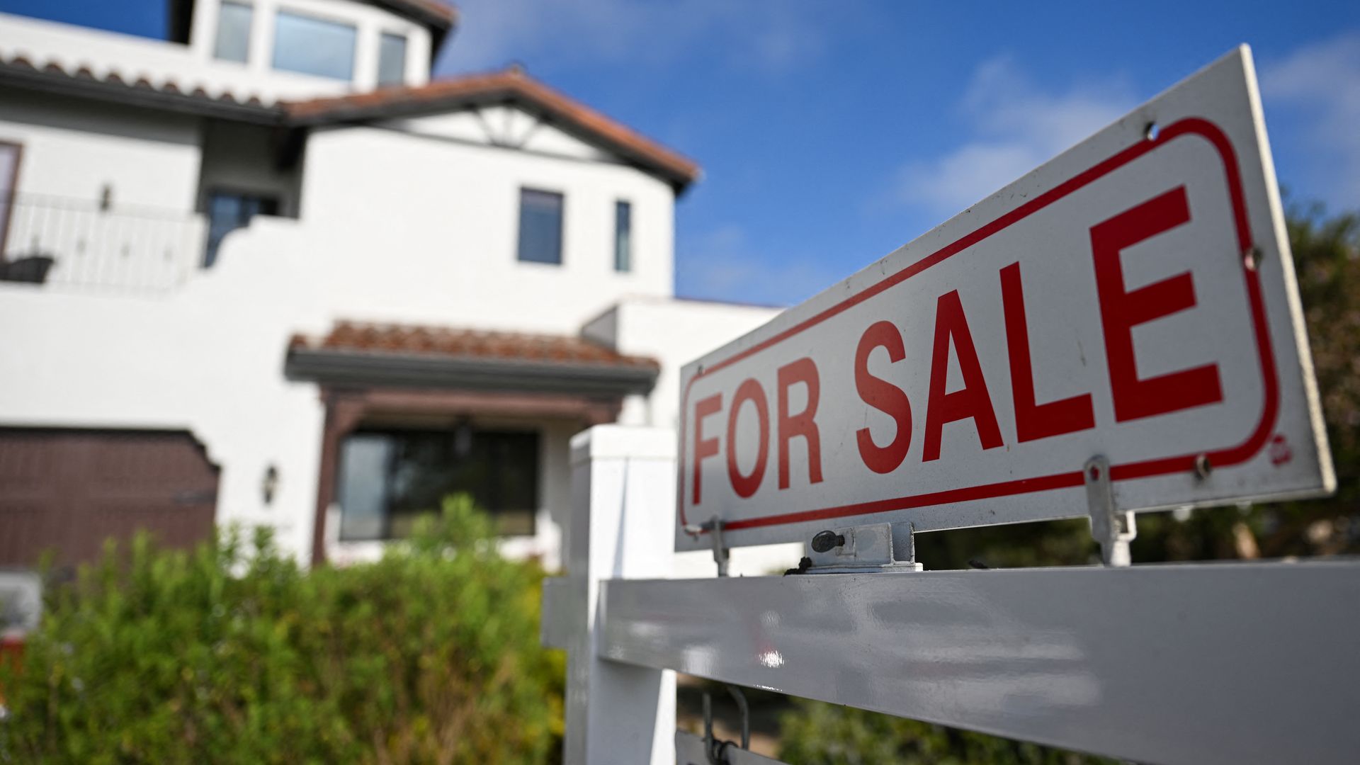 A for sale sign in front of a house