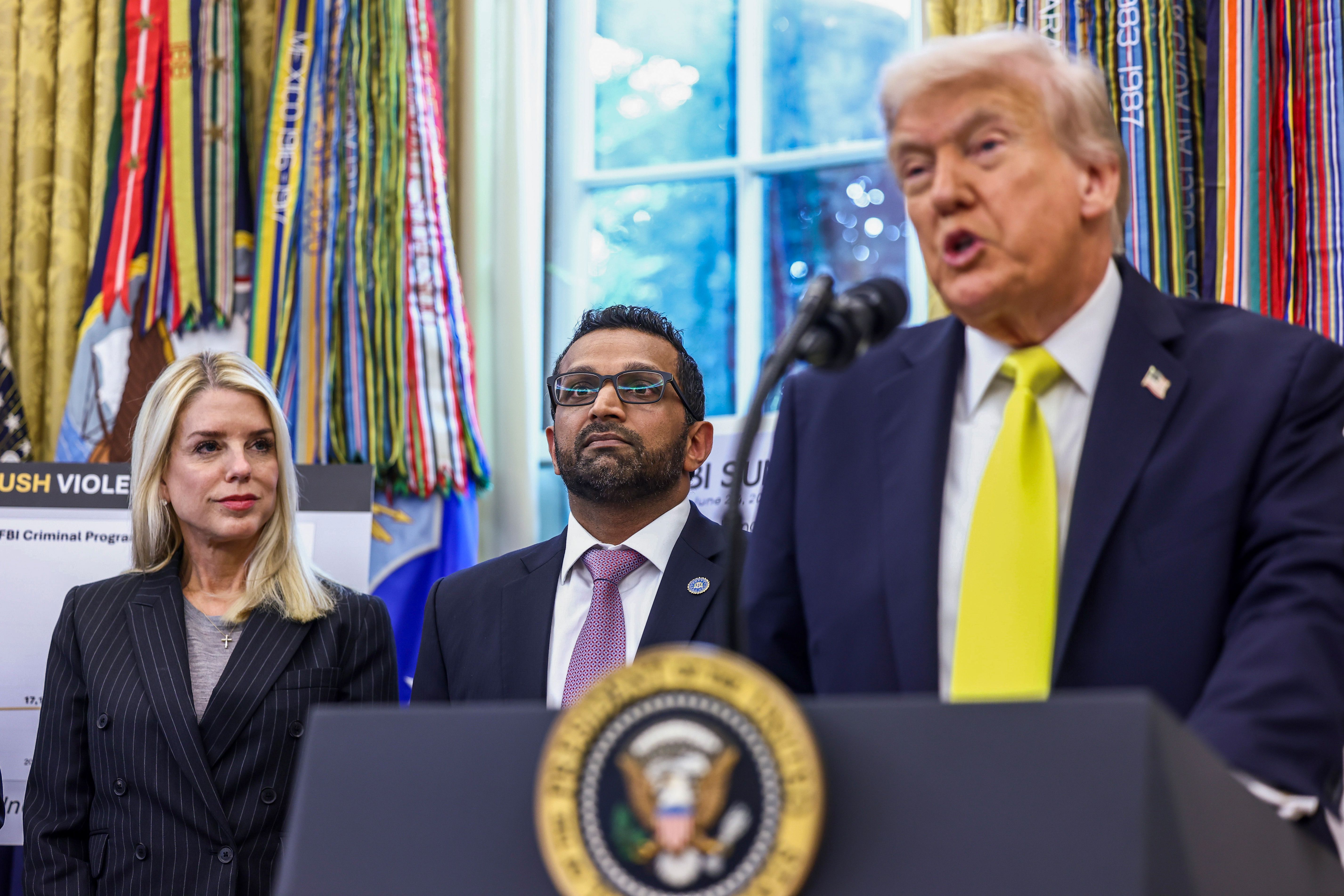 Pam Bondi, US attorney general, left, Kash Patel, director of the Federal Bureau of Investigation (FBI), center, and US President Donald Trump during a news conference in the Oval Office of the White House in Washington, DC, US, on Wednesday, Oct. 15, 2025. Trump said that he is "strongly recommendi