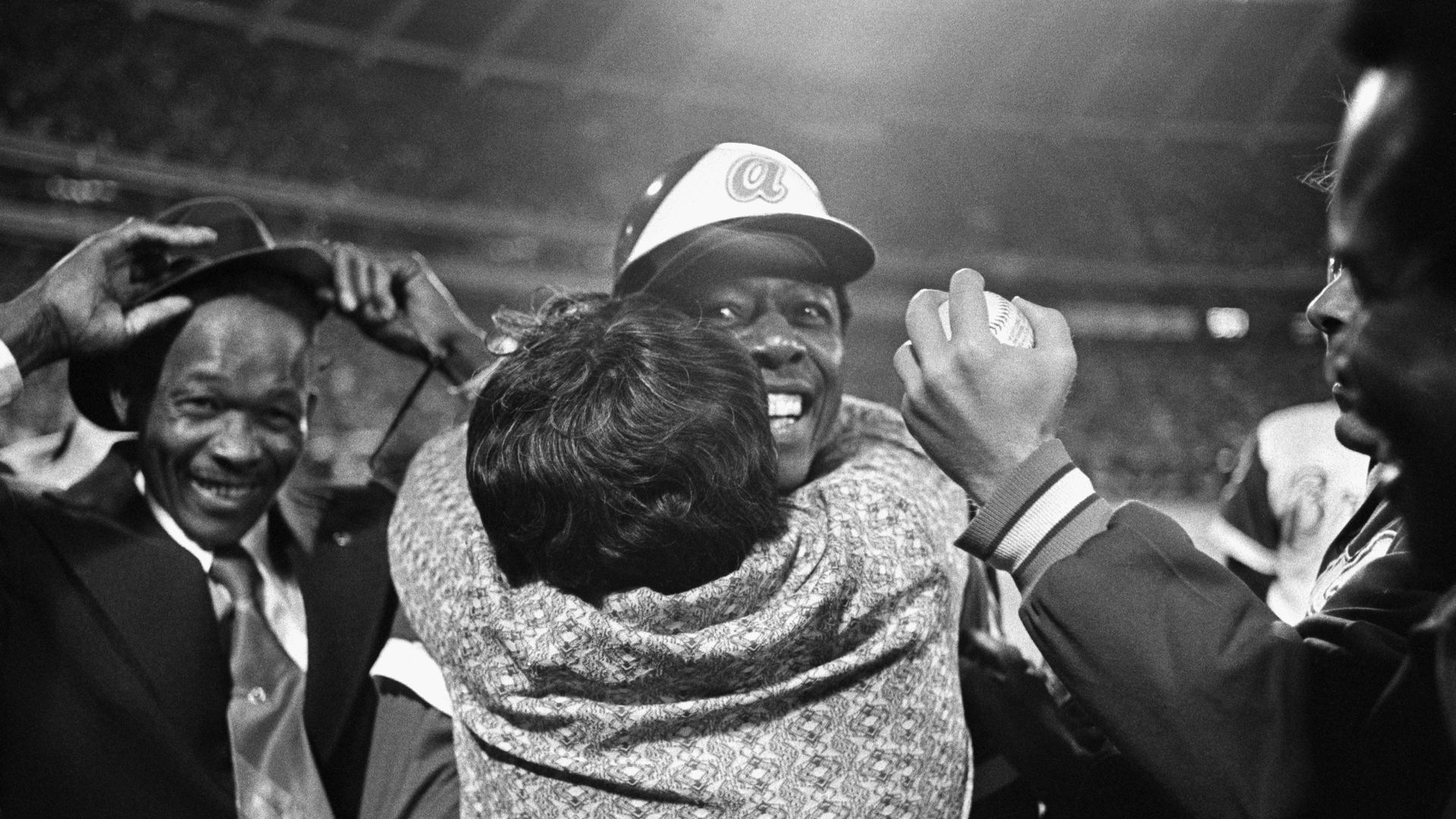 Hank Aaron's mother, Estella, hugs him after he breaks Babe Ruth's all-time home run record on April 8, 1974. 