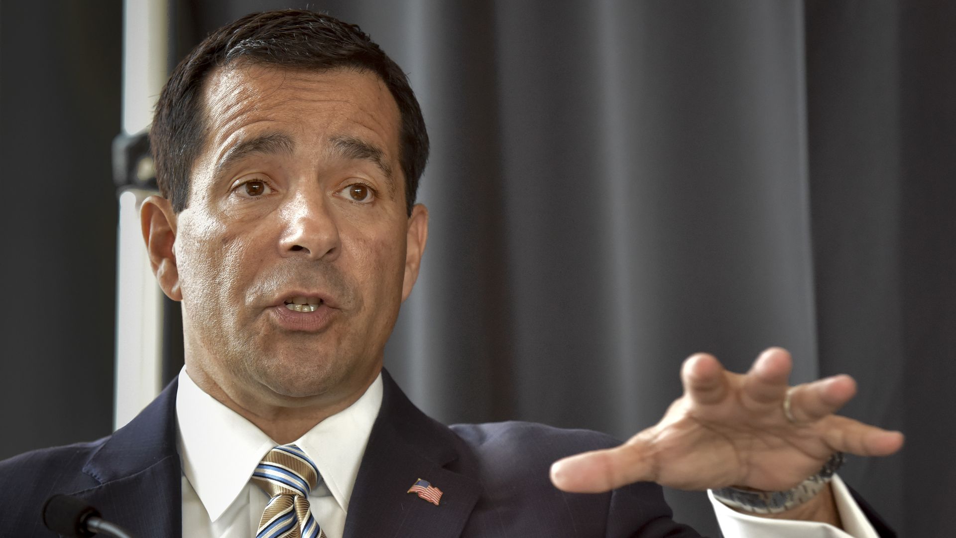 William Evanina sits in a suit and tie 