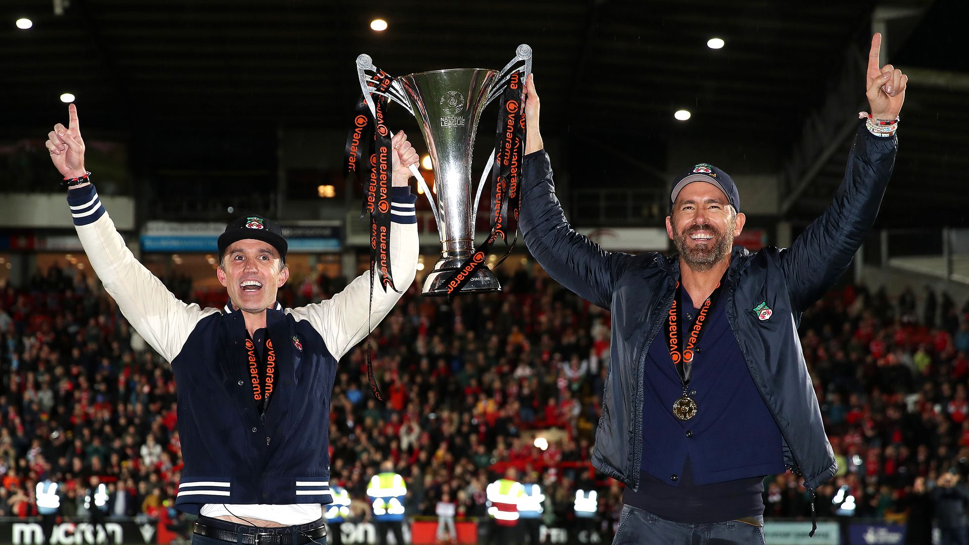 ryan reynolds and rob mcelhenney holding up trophy