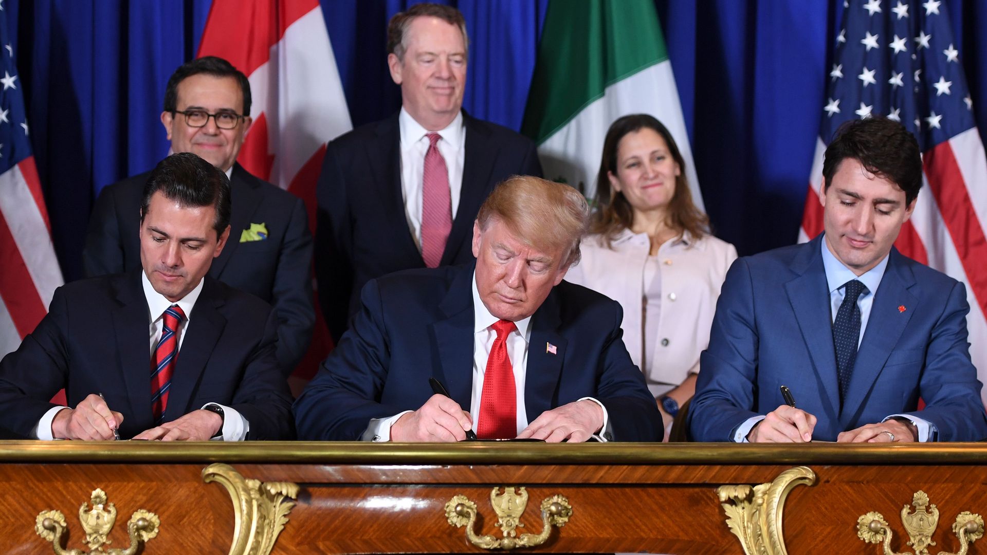 Mexico's President Enrique Pena Nieto US President Donald Trump and Canadian Prime Minister Justin Trudeau signing a trade deal