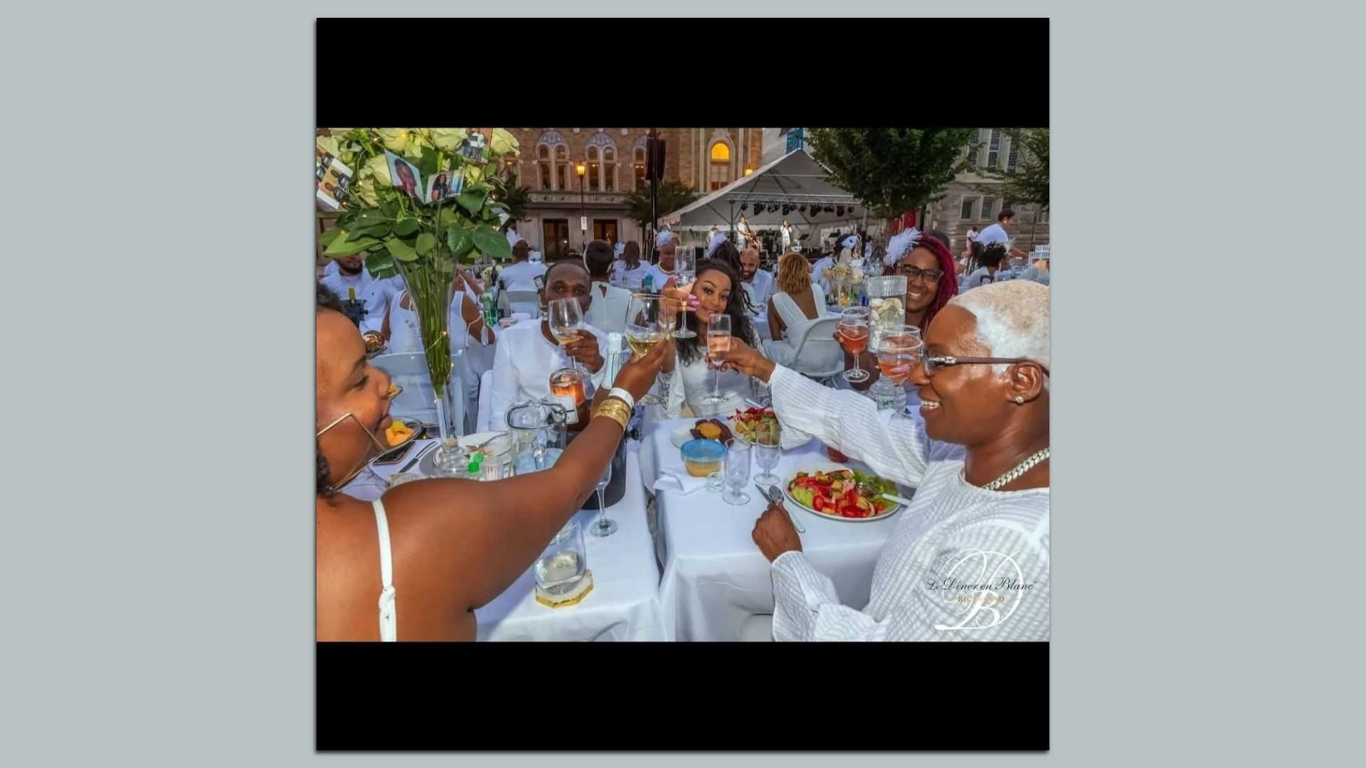 woman toast around an all white table 