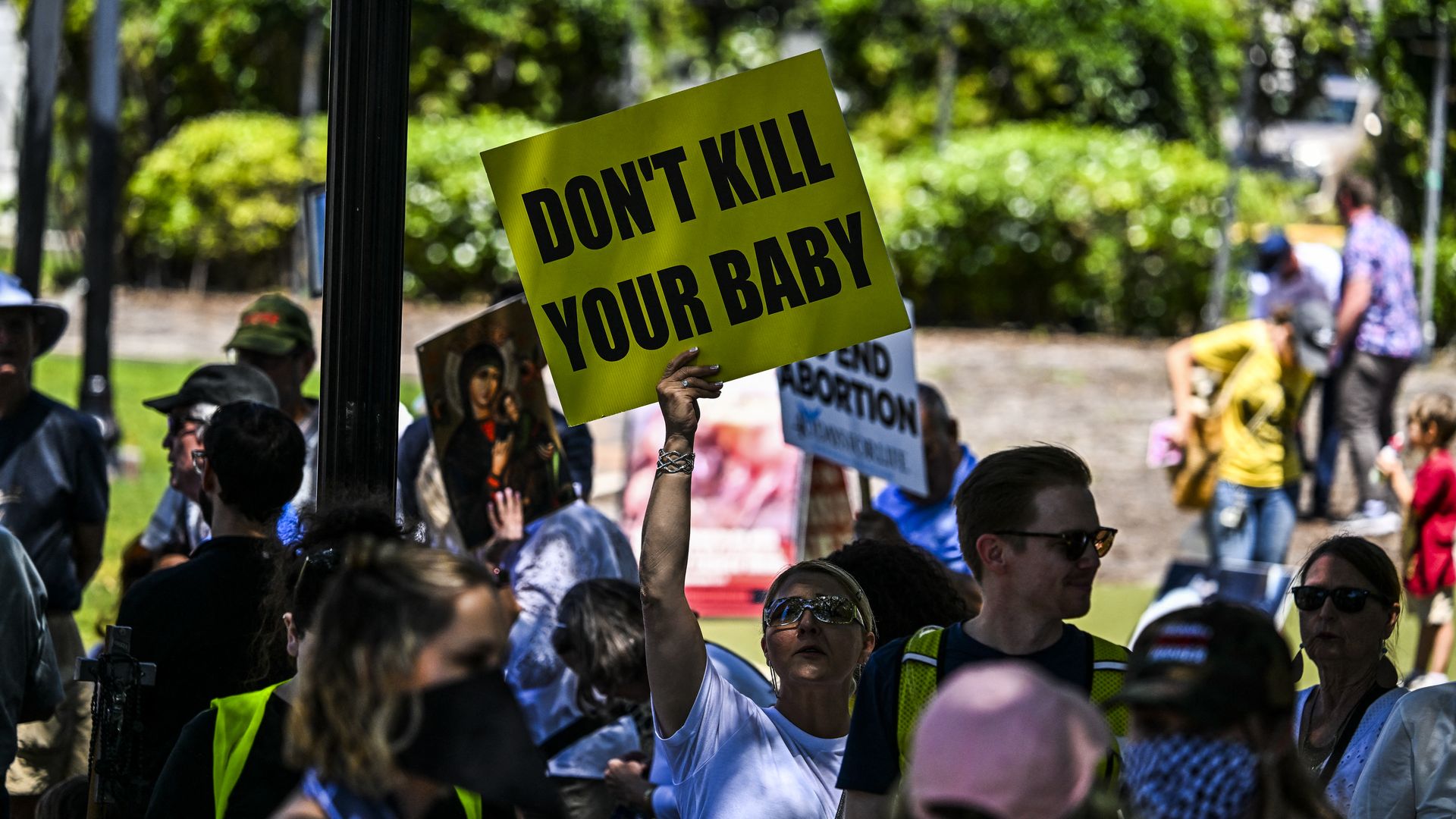 Anti-abortion activists protest near the "Rally for Our Freedom" to protect abortion rights for Floridians, in Orlando, Florida, on April 13, 2024. Florida Rising, Floridians Protecting Freedom, and coalition partners officially launched the "Yes on 4" campaign. Florida's Supreme Court on April 1, 2