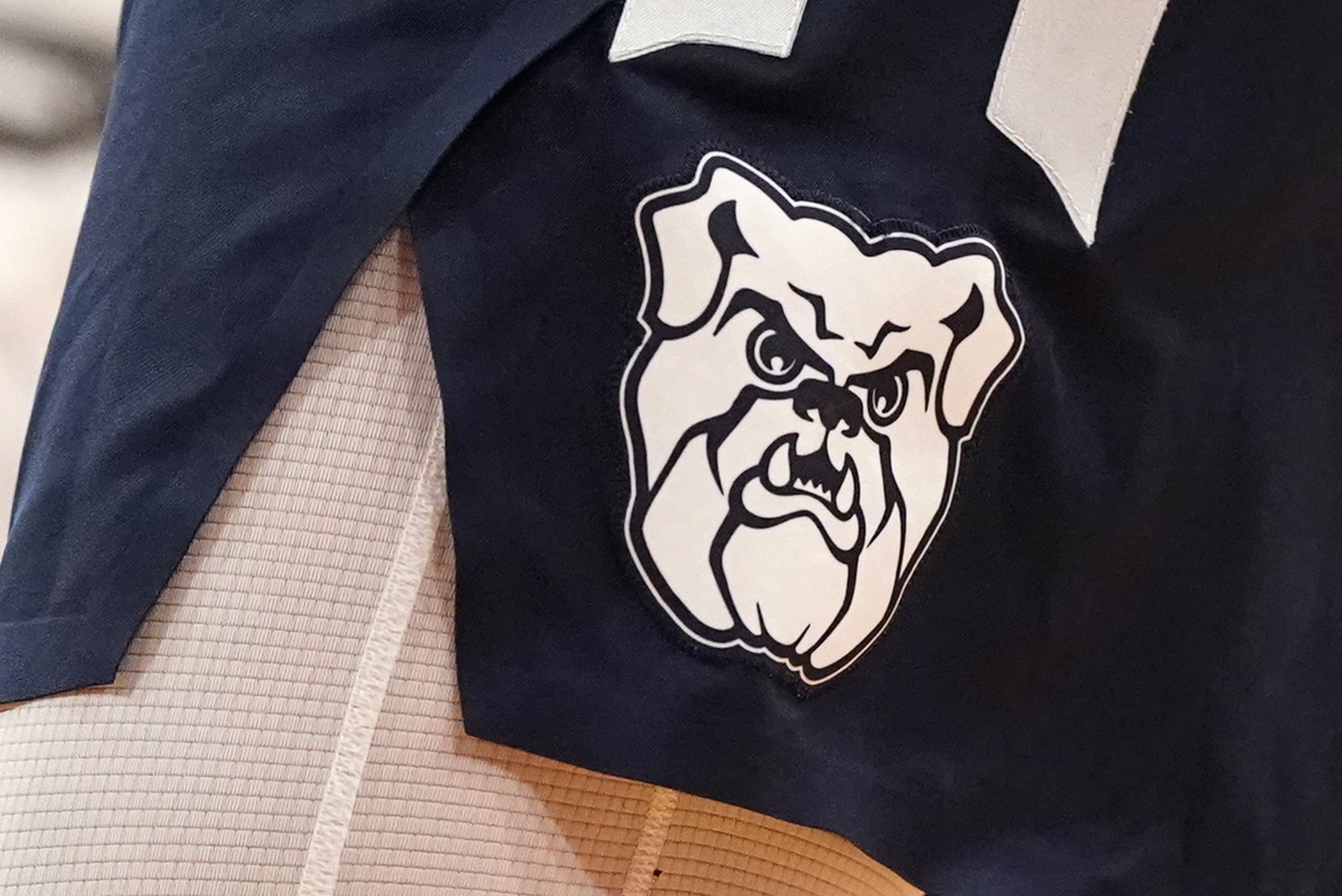 A logo of a bulldog on a pair of basketball shorts 