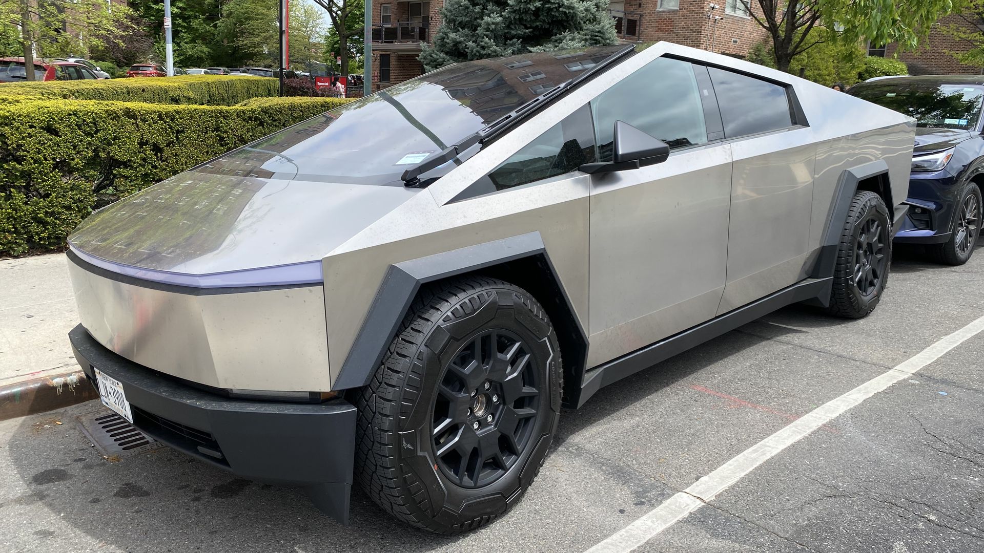 A Tesla Cybertruck is parked on the street. 