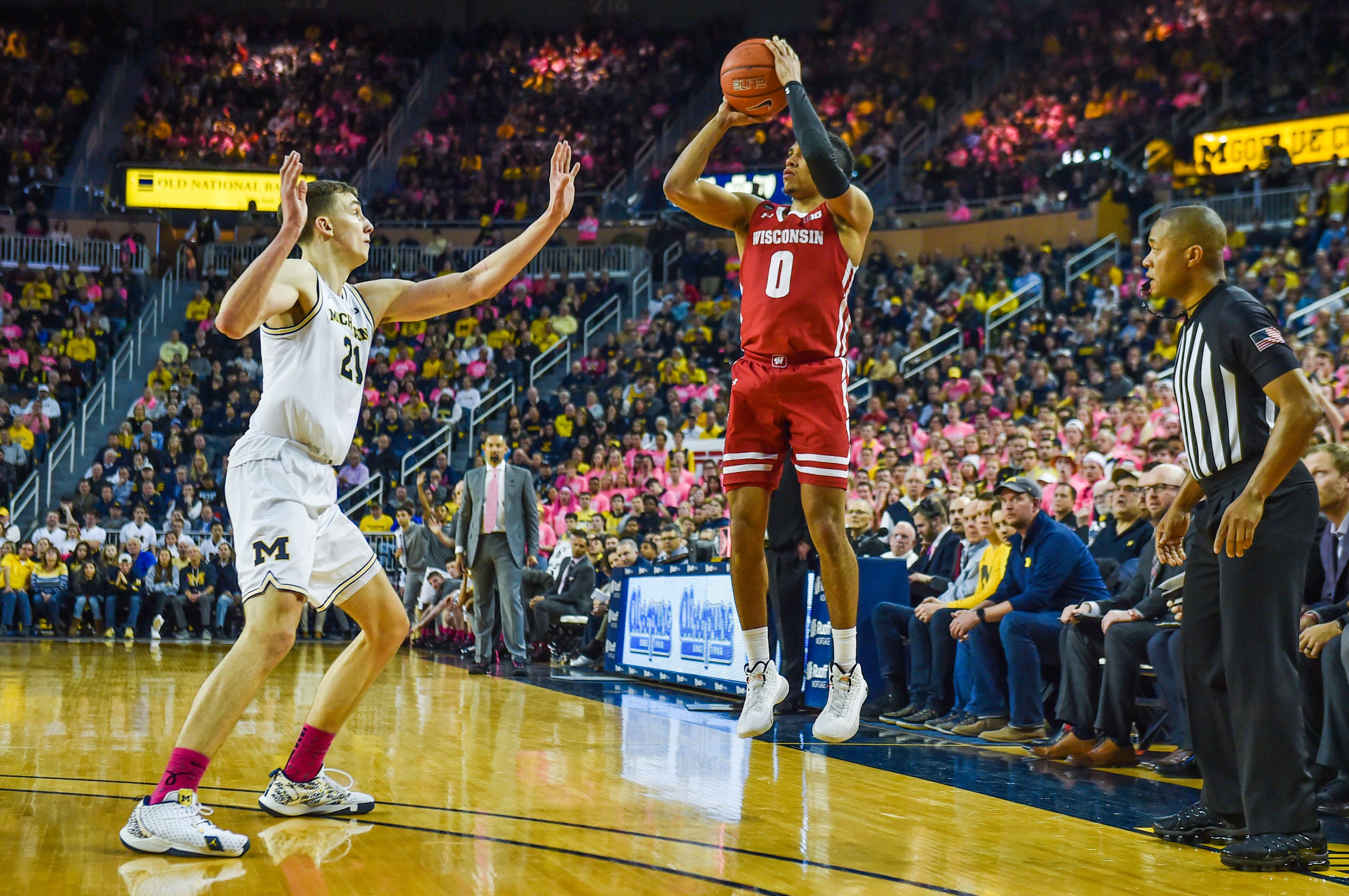 Wisconsin Badgers player shooting a three