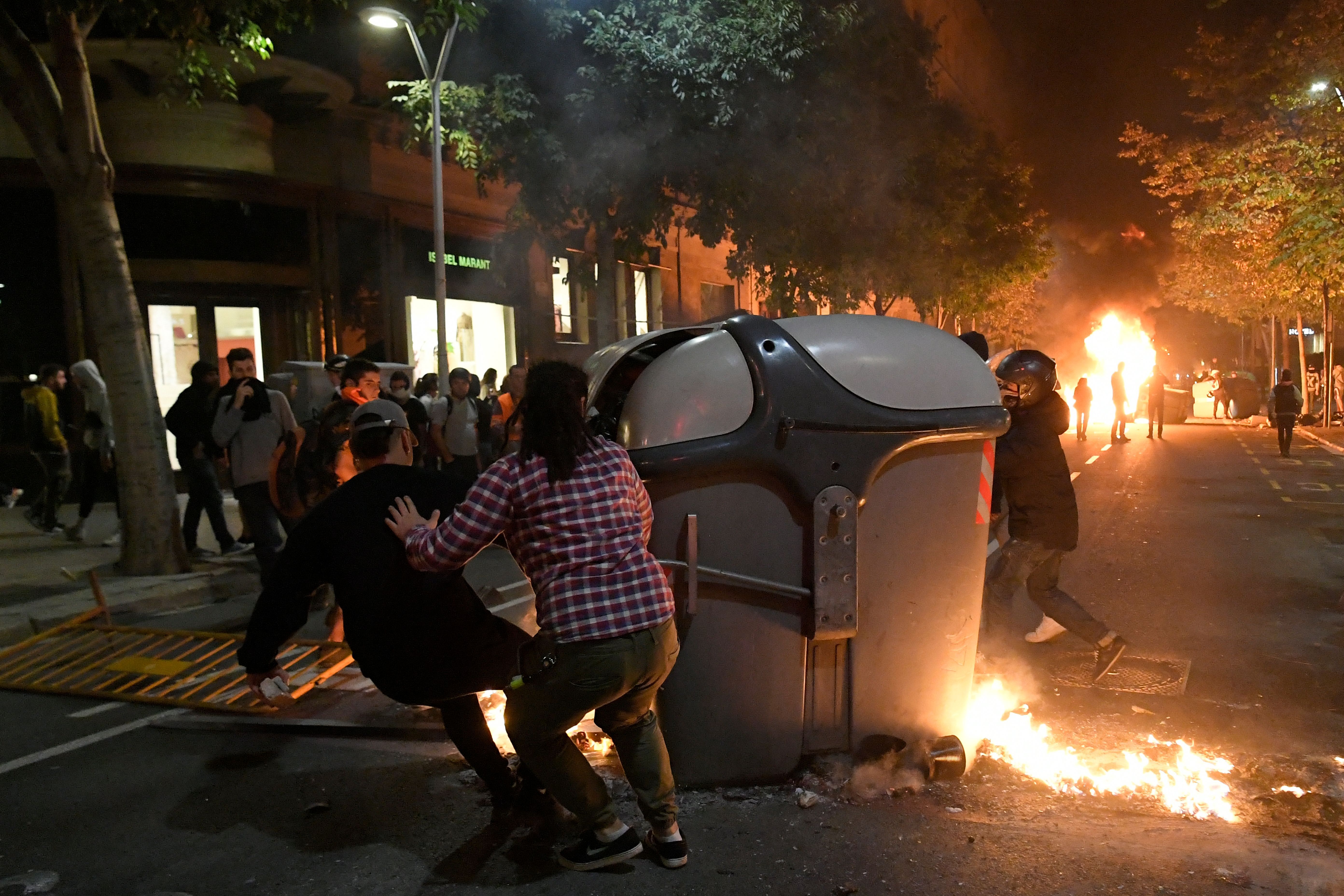 Protesters burn garbage containers during protests in Barcelona on October 15