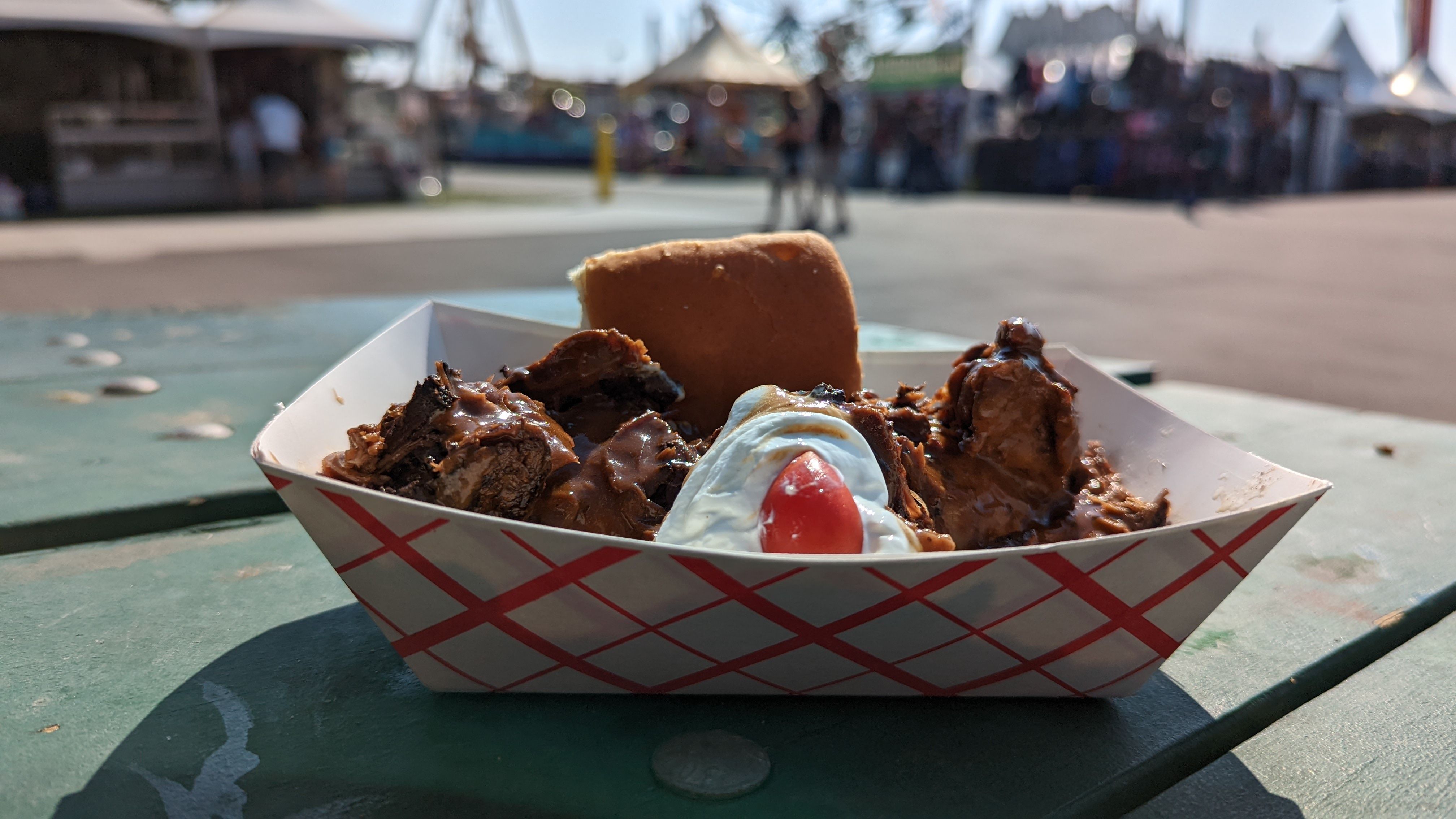 Stewed beef, sour cream, a cherry tomato and a dinner roll make a hot beef sundae at the Utah State Fair. 