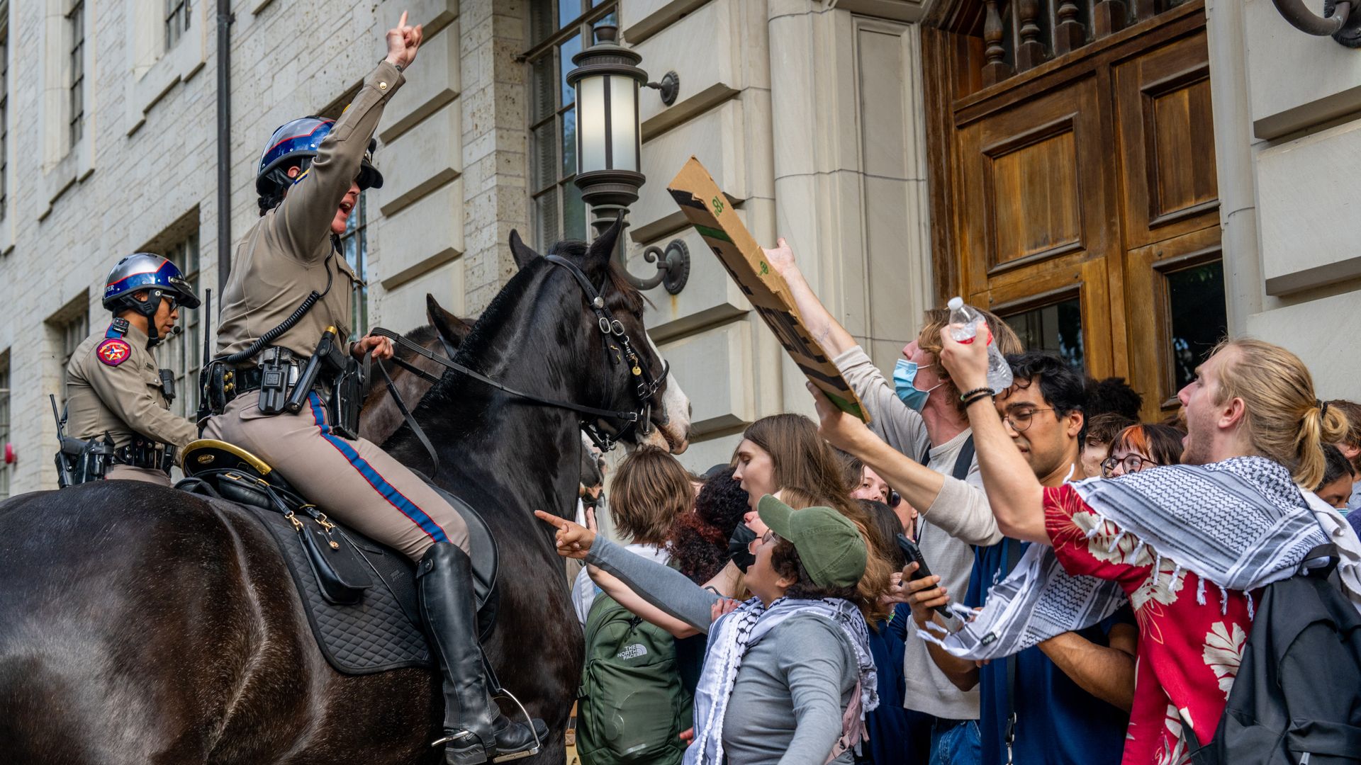 Mounted police contain shouting demonstrators protesting the war in Gaza at the University of Texas at Austin in April 2024.
