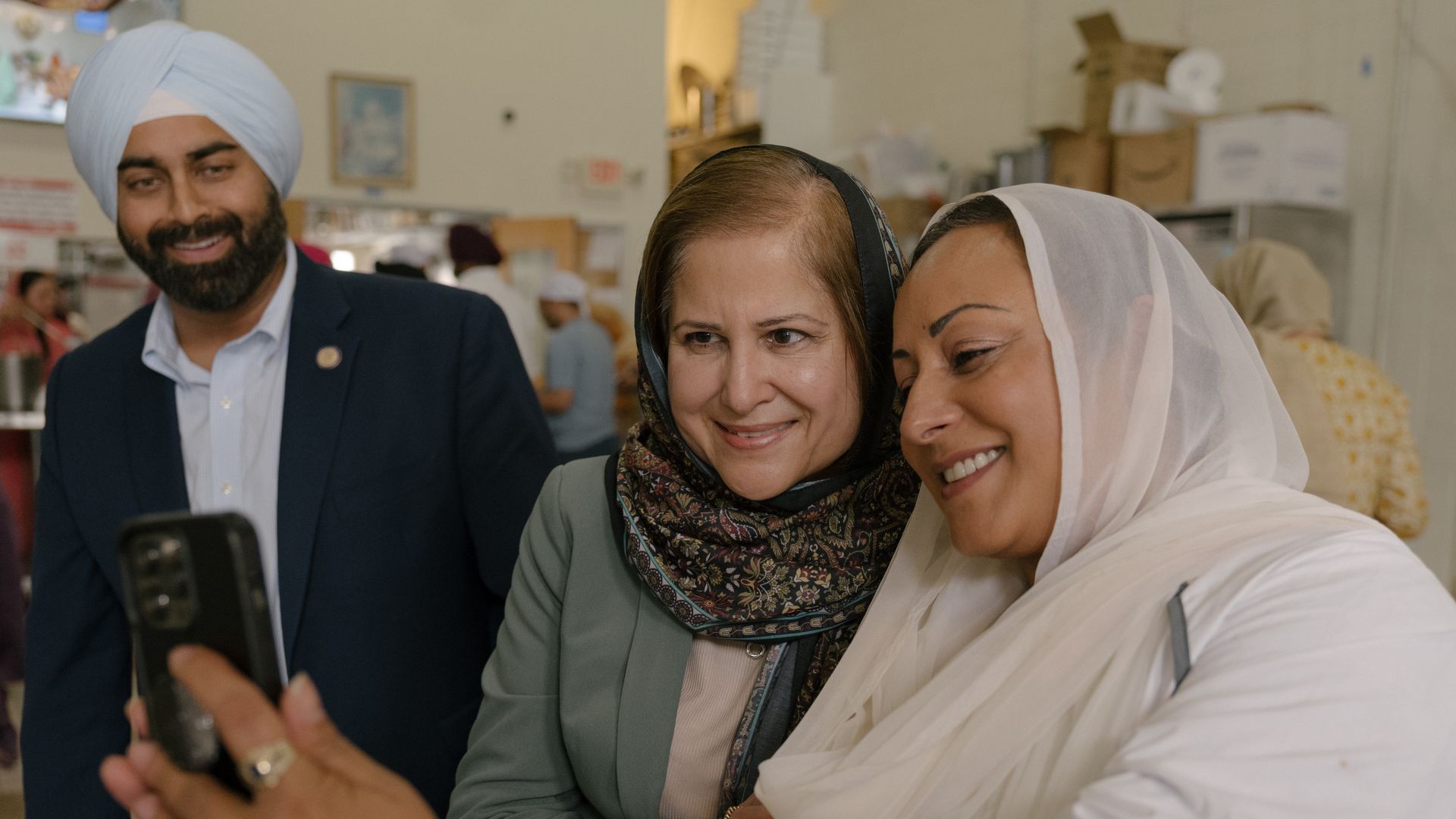 Ghazala Hashmi taking a selfie with a woman