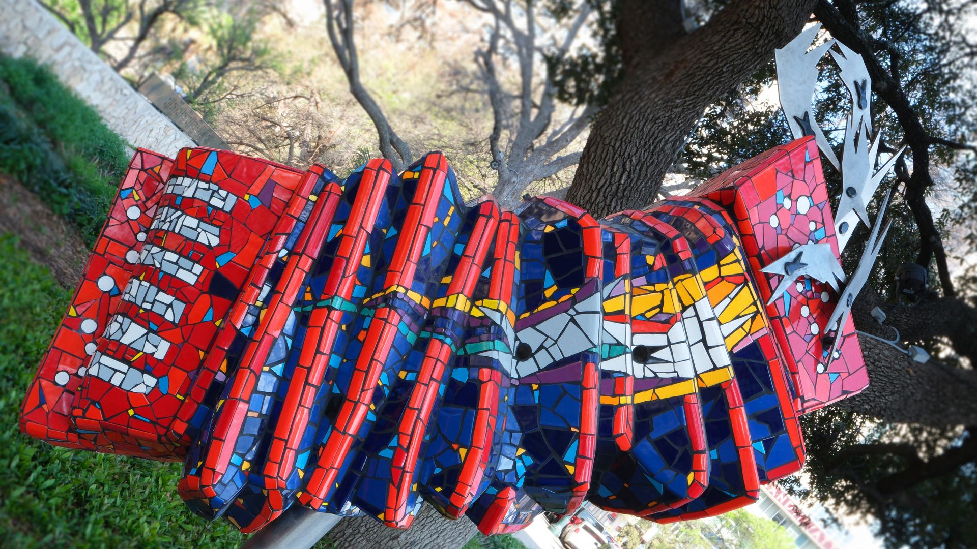 A mosaic accordion sculpture in red and blue colors.