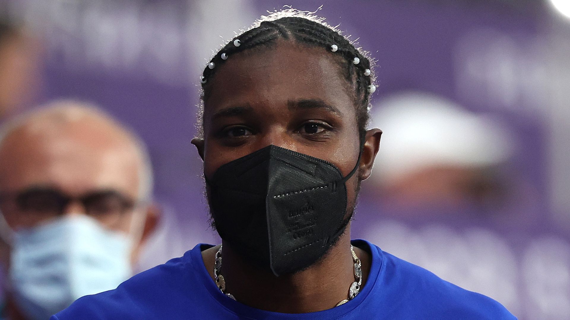 Noah Lyles wears a black mask